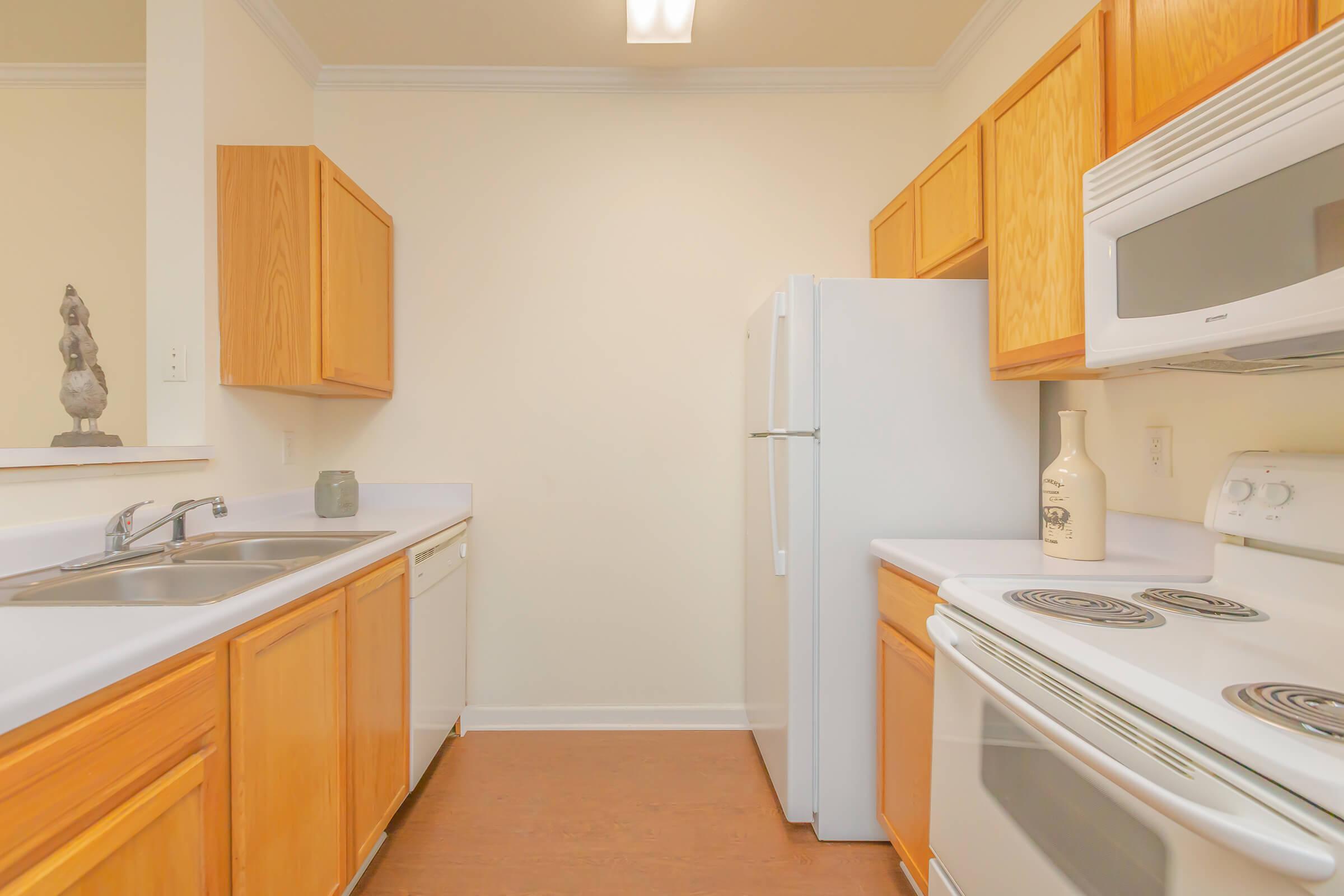 a kitchen with a sink and a refrigerator