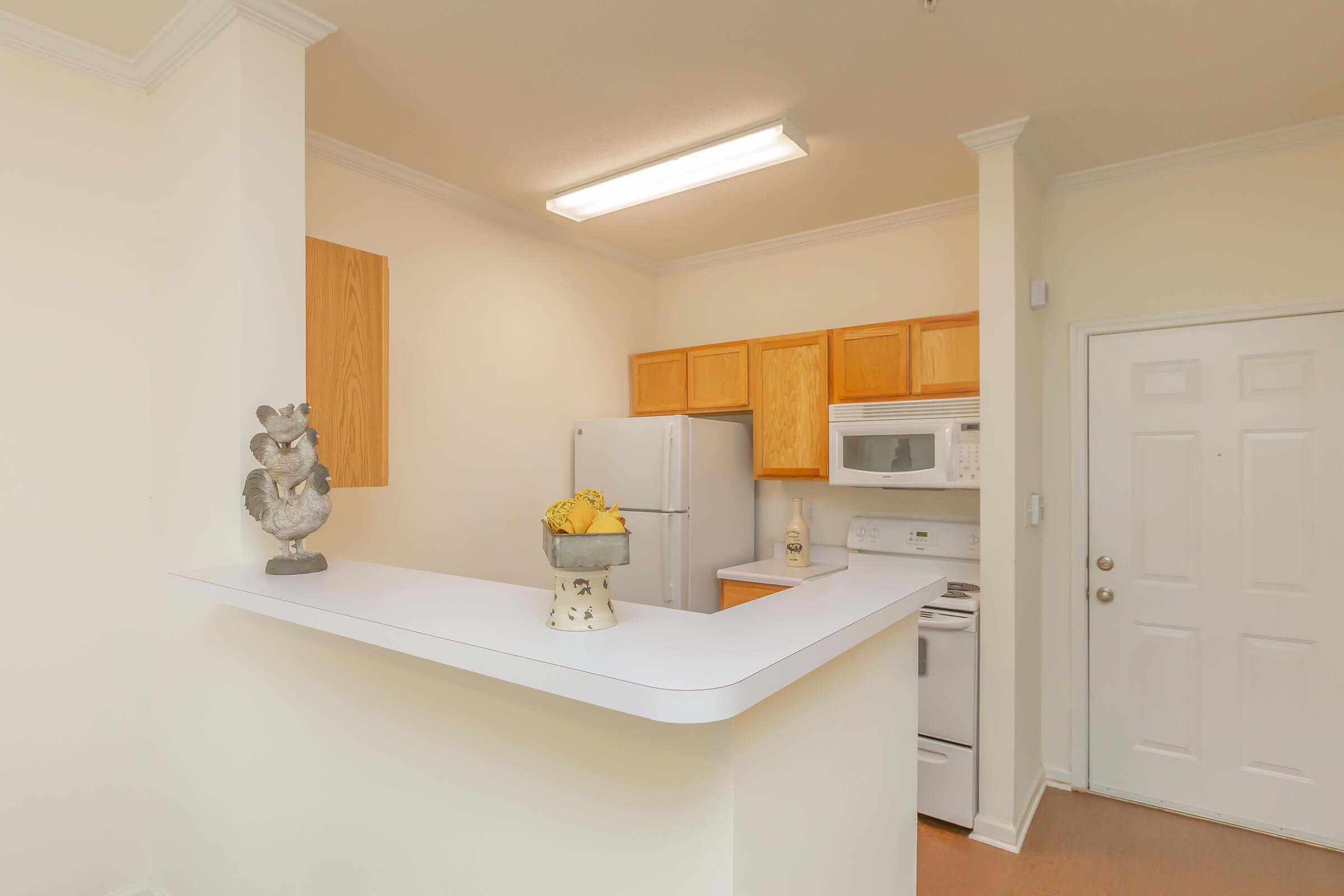 a white refrigerator freezer sitting inside of a kitchen