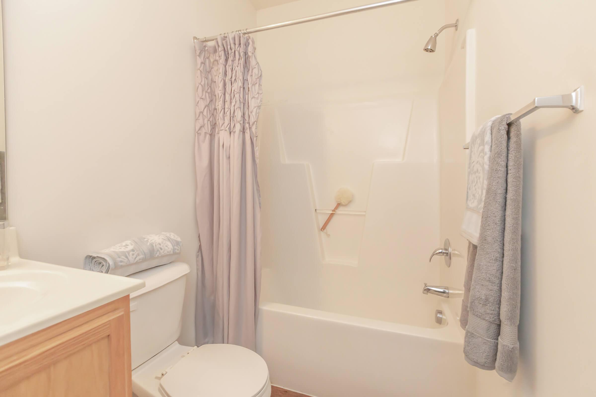 a white sink sitting next to a shower