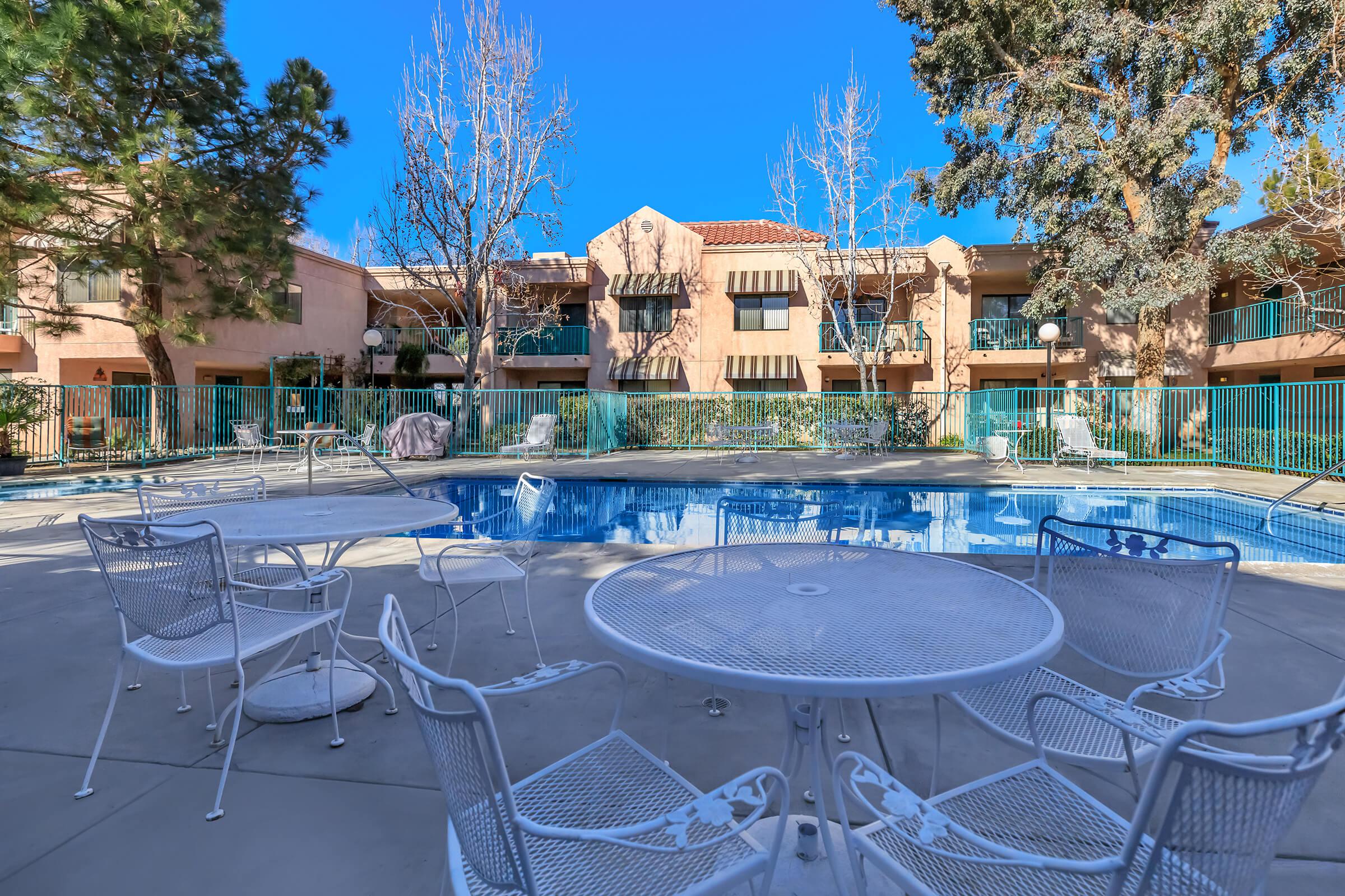 Cedar Town Square community pool with white tables and chairs