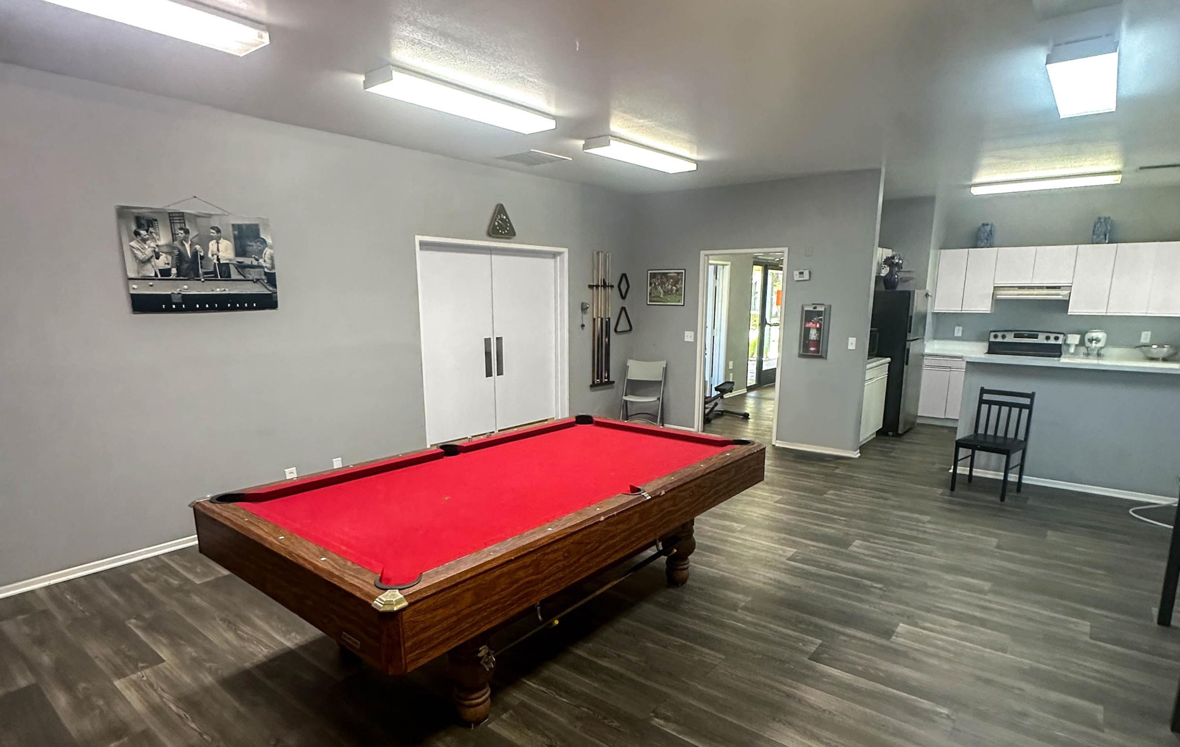 Cedar Town Square common area with resident kitchen and pool table