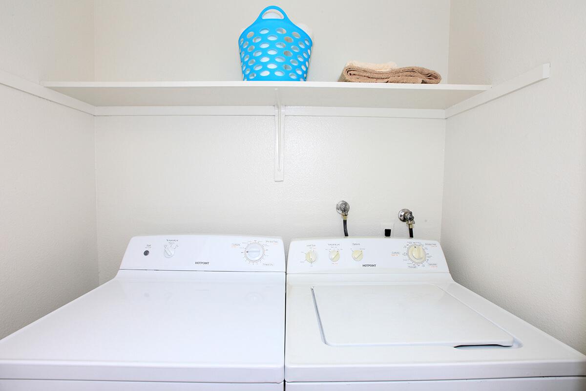 a white sink sitting under a microwave