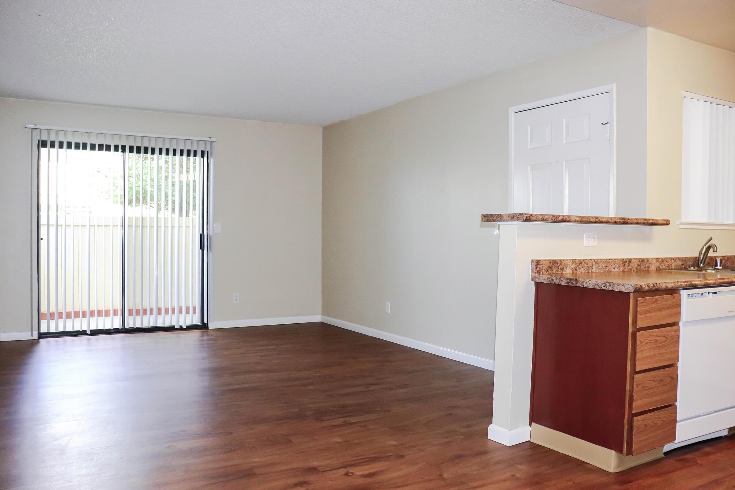 a large empty room with a wood floor