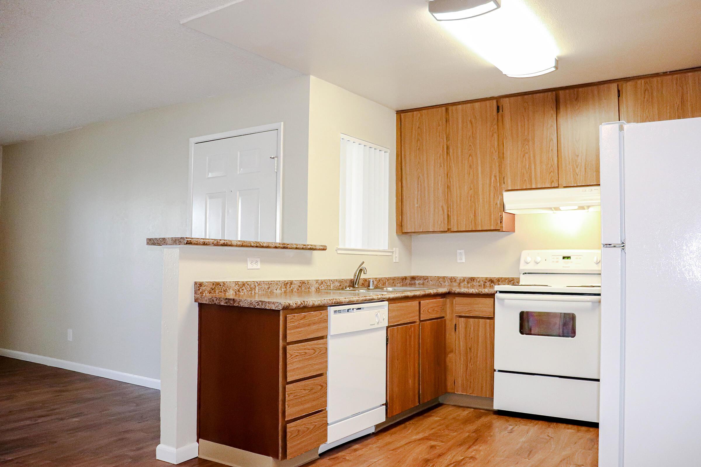 a kitchen with a stove and a refrigerator