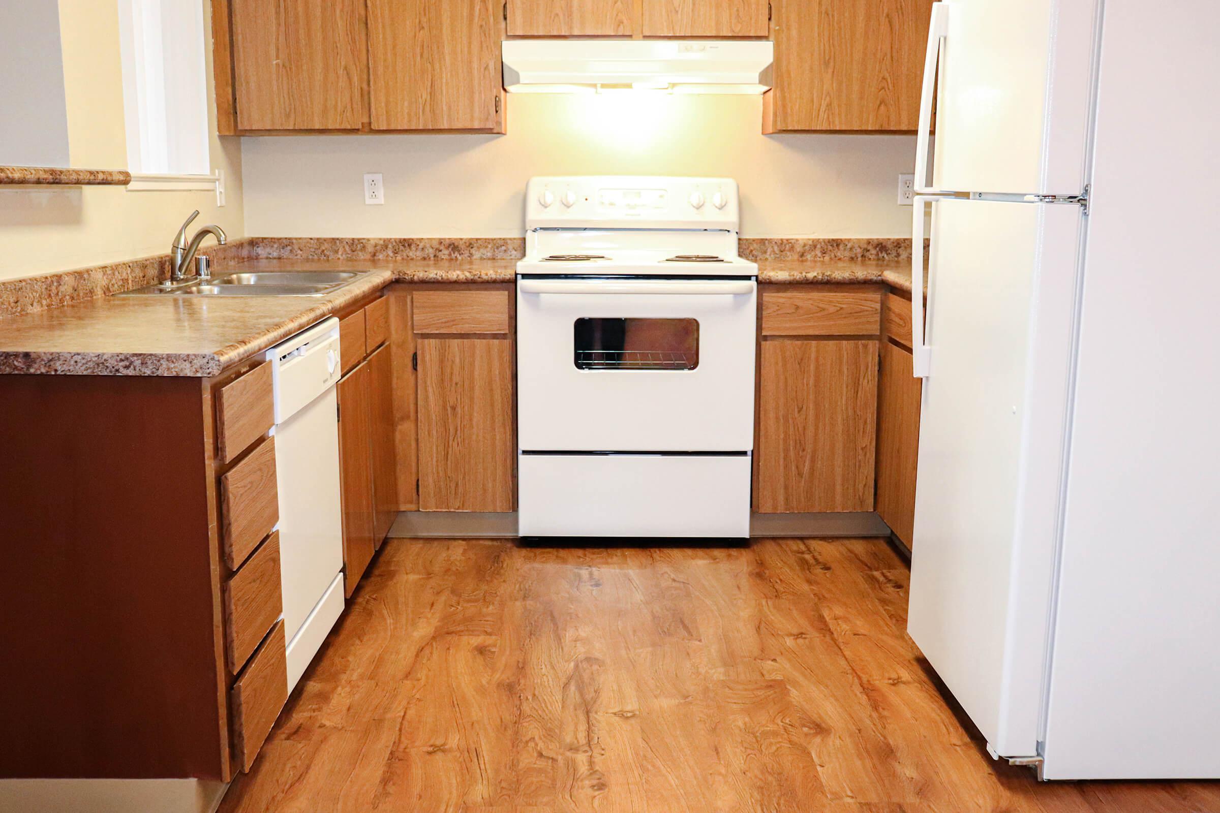 a kitchen with a white stove top oven sitting inside of a refrigerator
