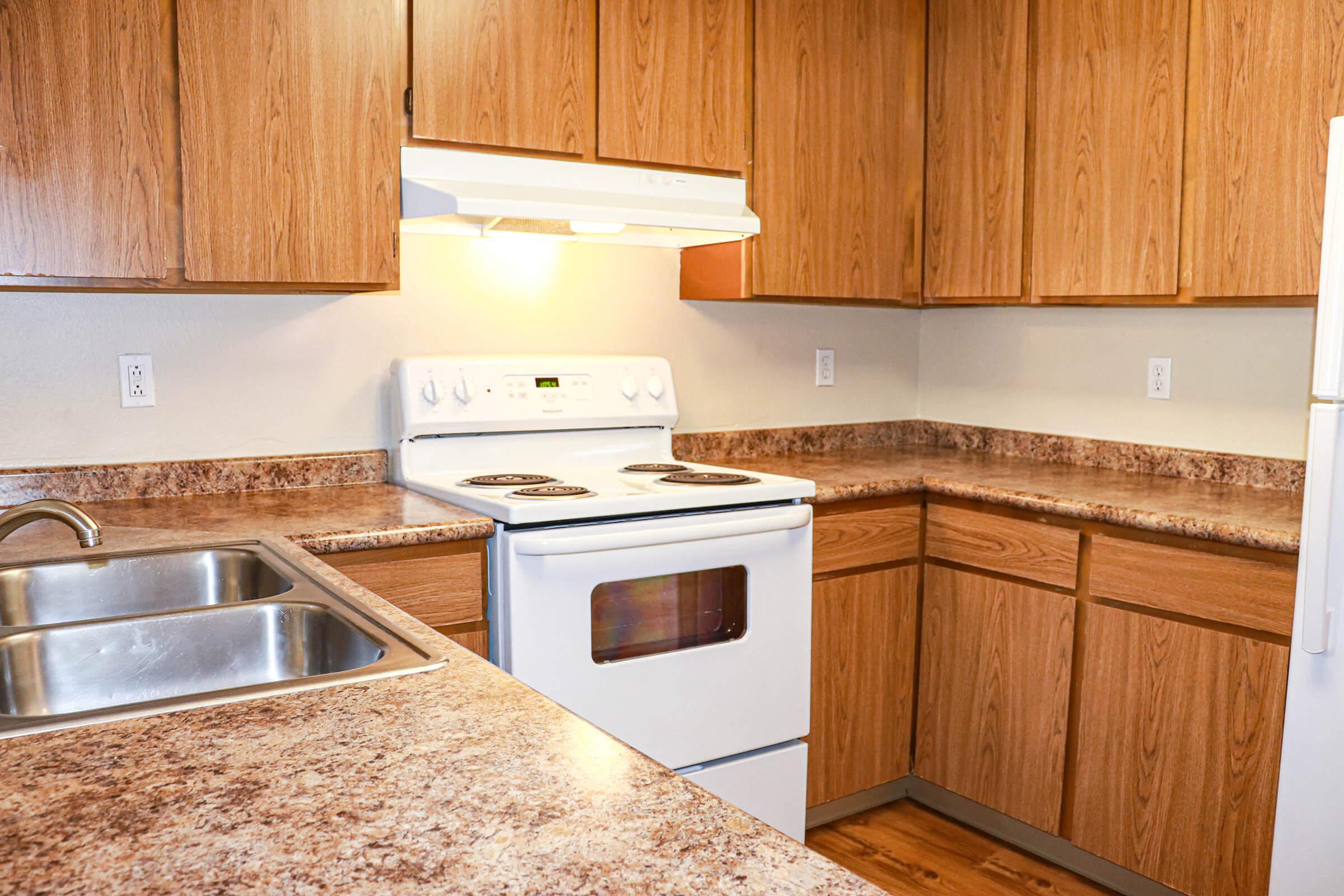 a kitchen with stainless steel appliances and wooden cabinets