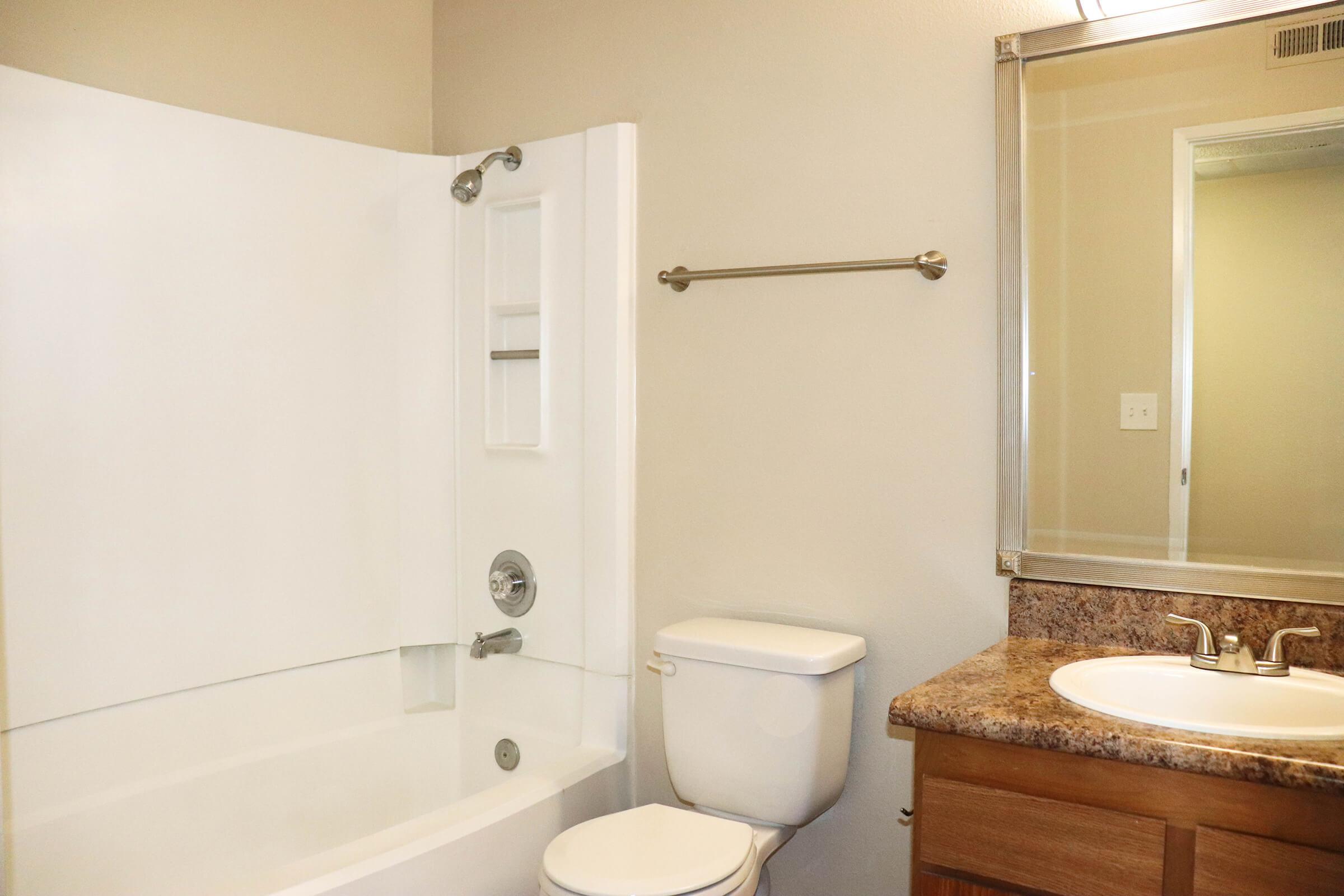 a white sink sitting next to a shower