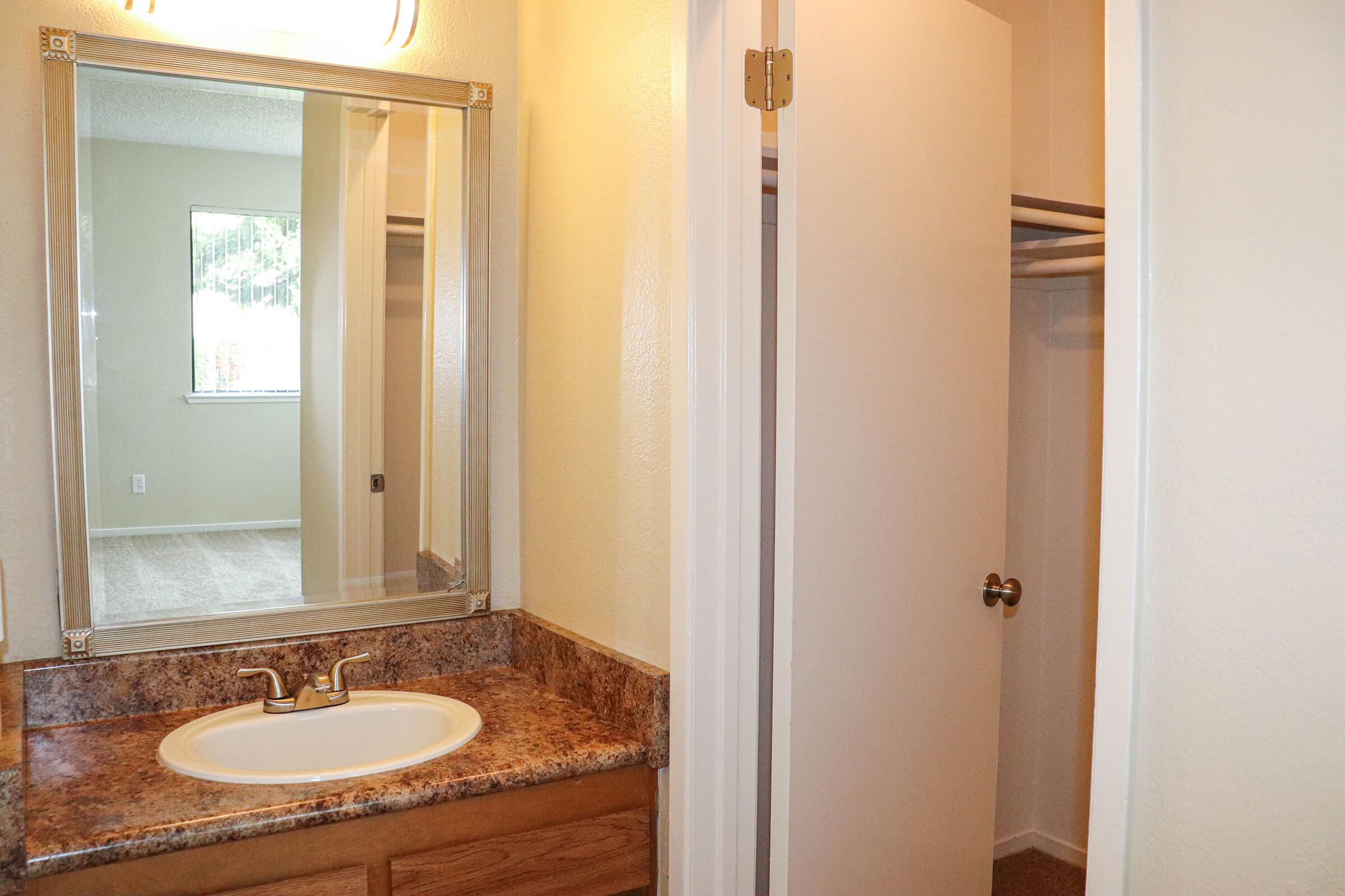 a room with a sink and a mirror