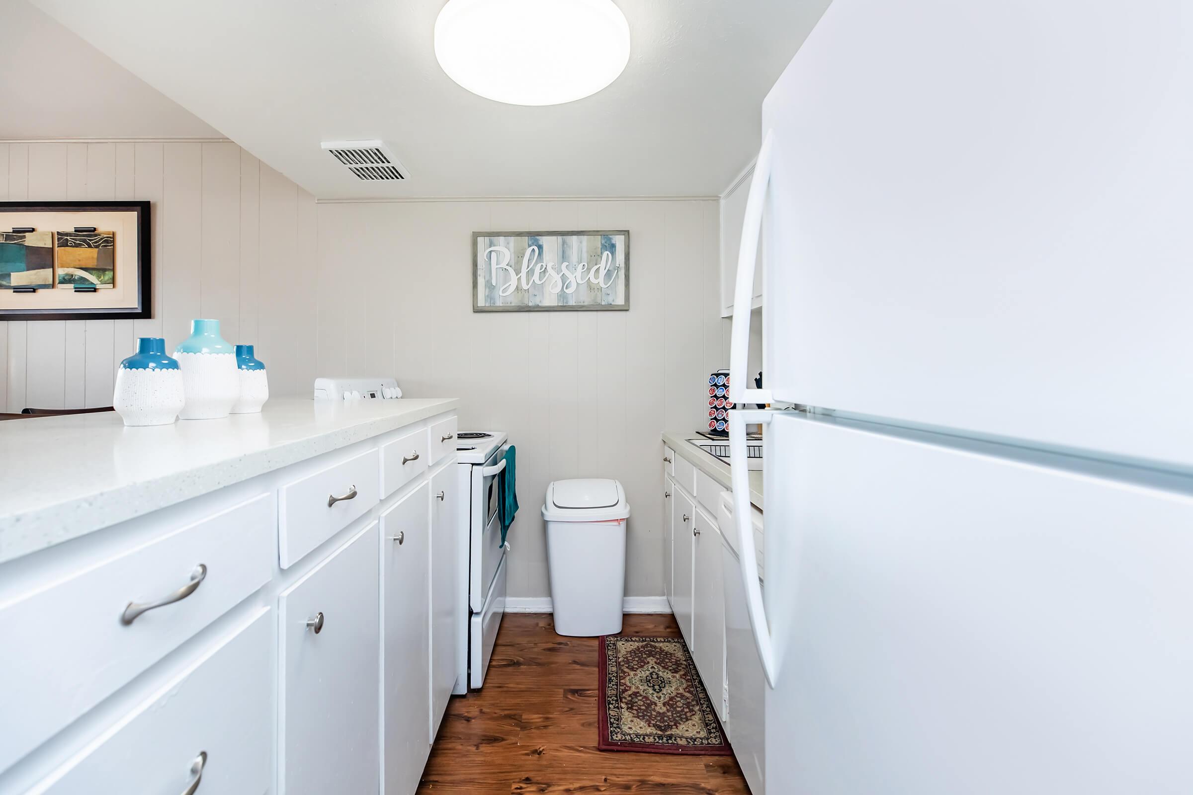 a kitchen with a sink and a refrigerator