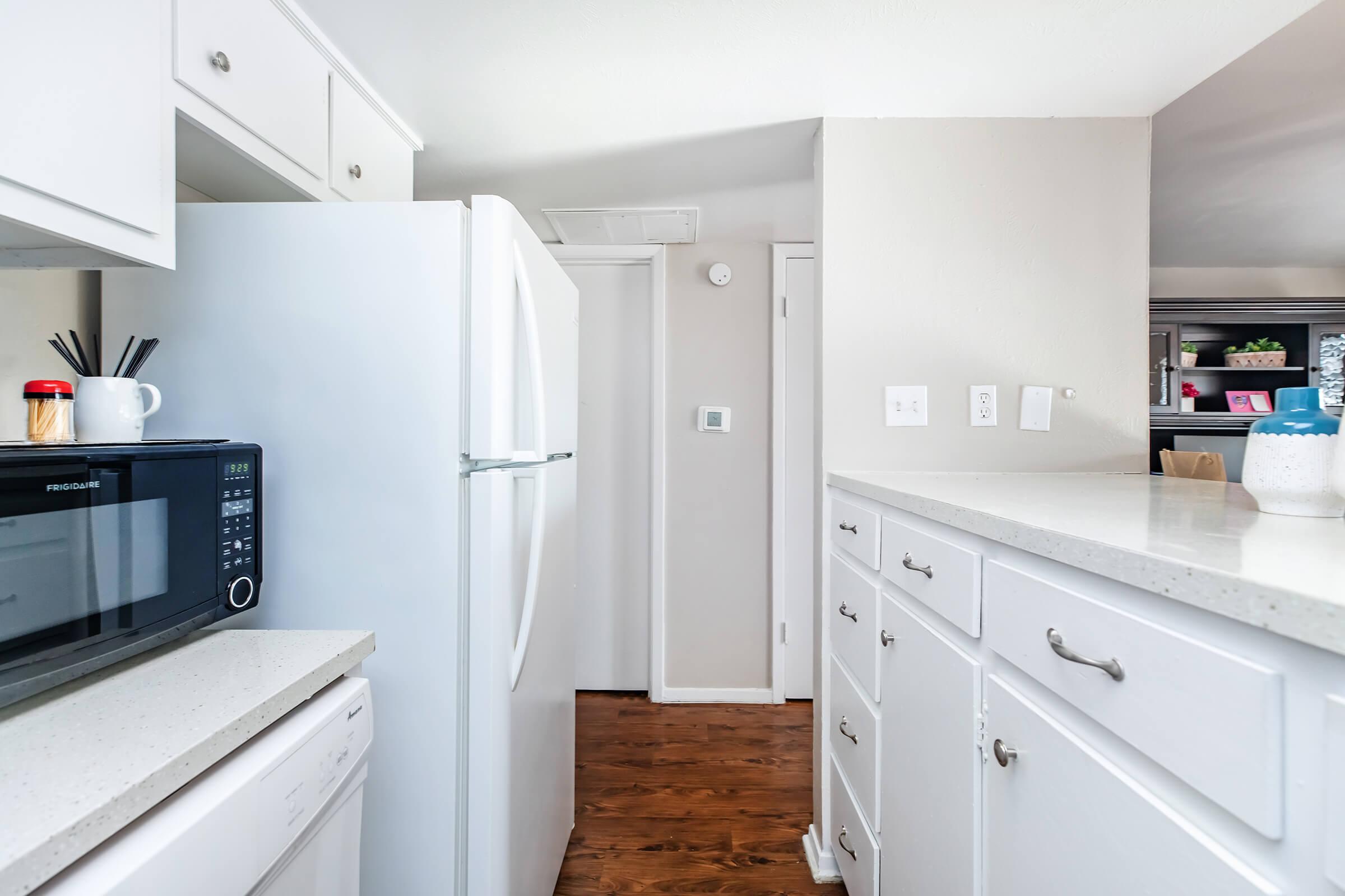 a kitchen with a stove sink and refrigerator