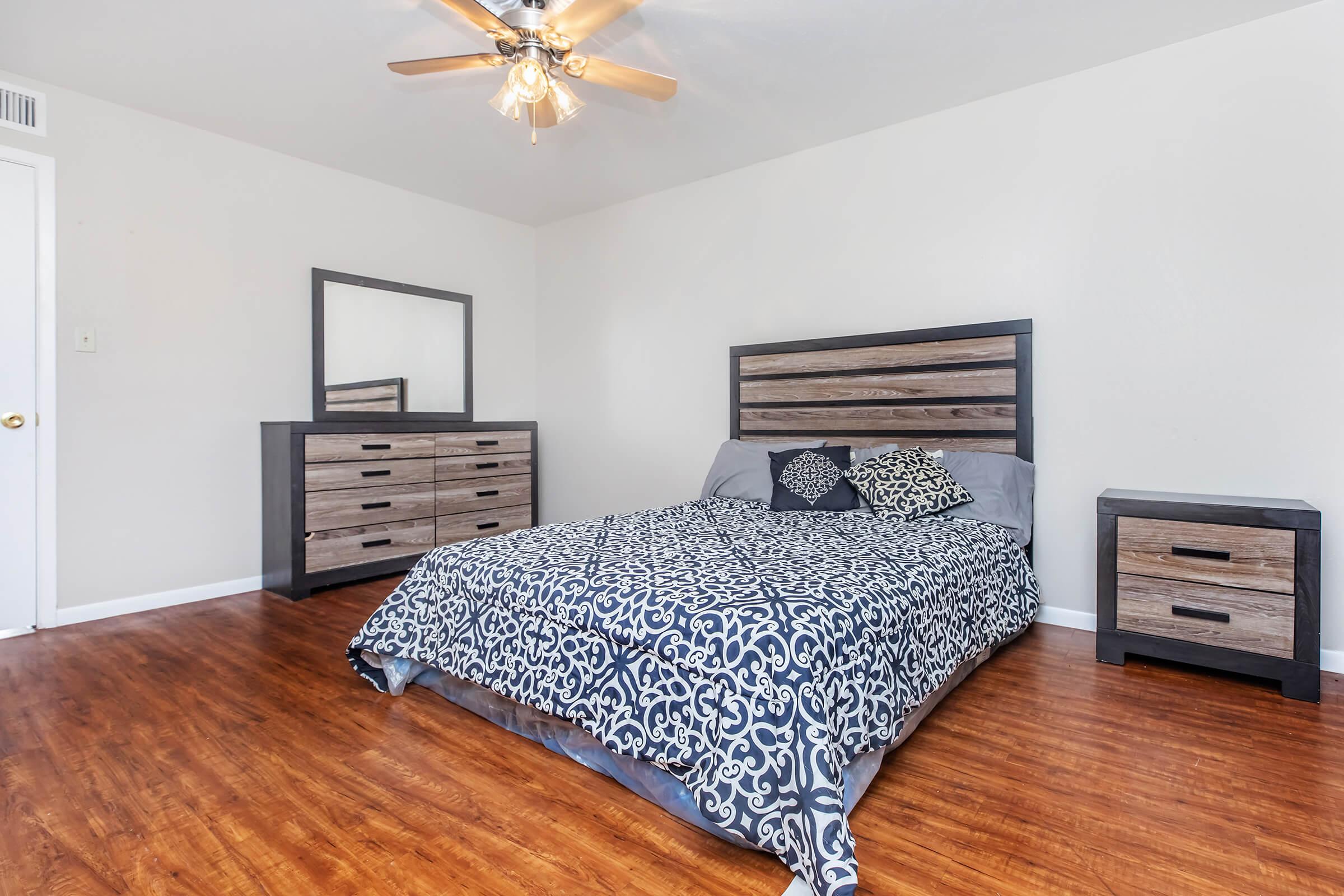 a bedroom with a wooden floor