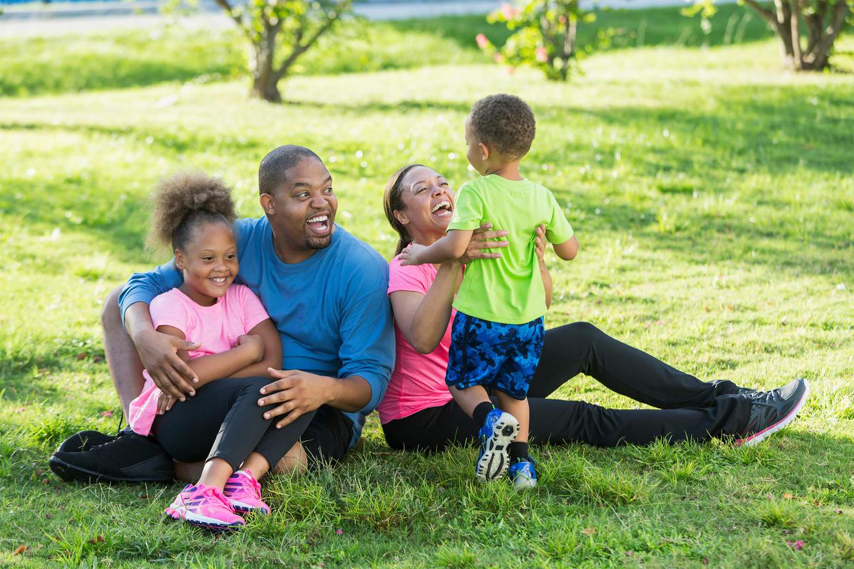 family sitting on ground in park iStock-618637194.jpg