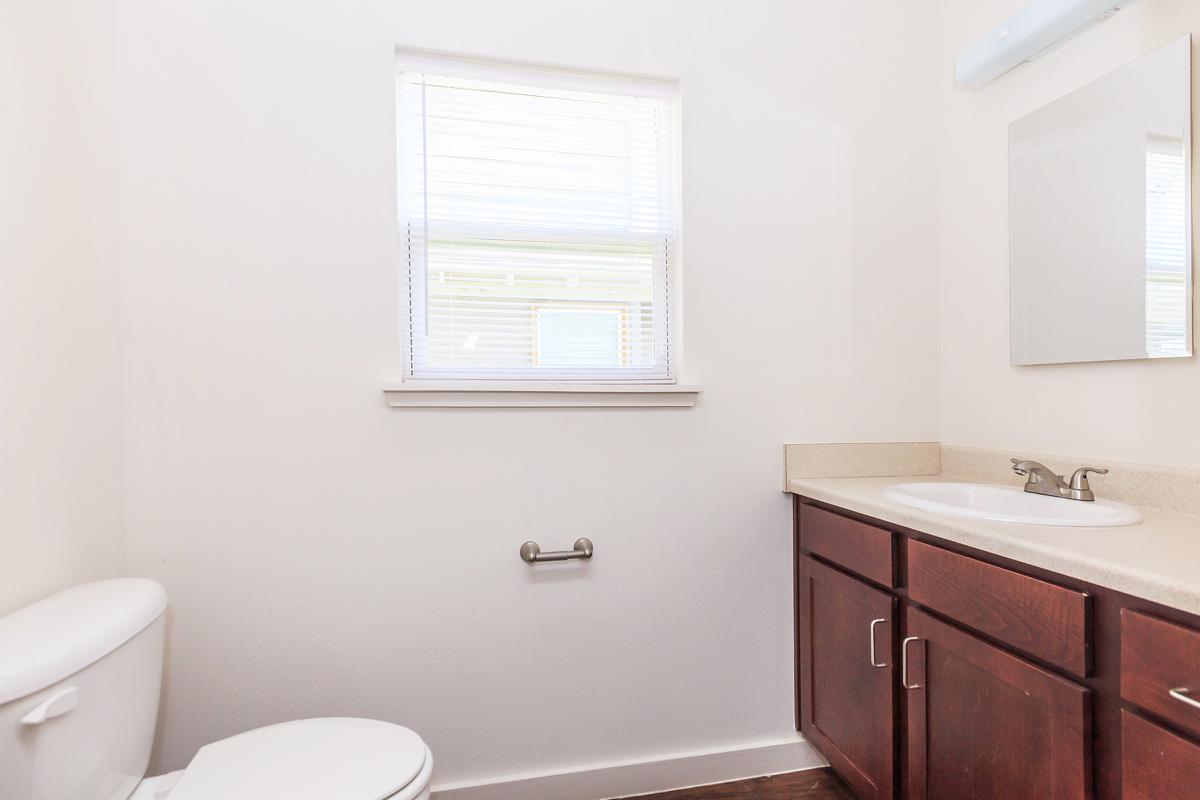 a white sink sitting under a window