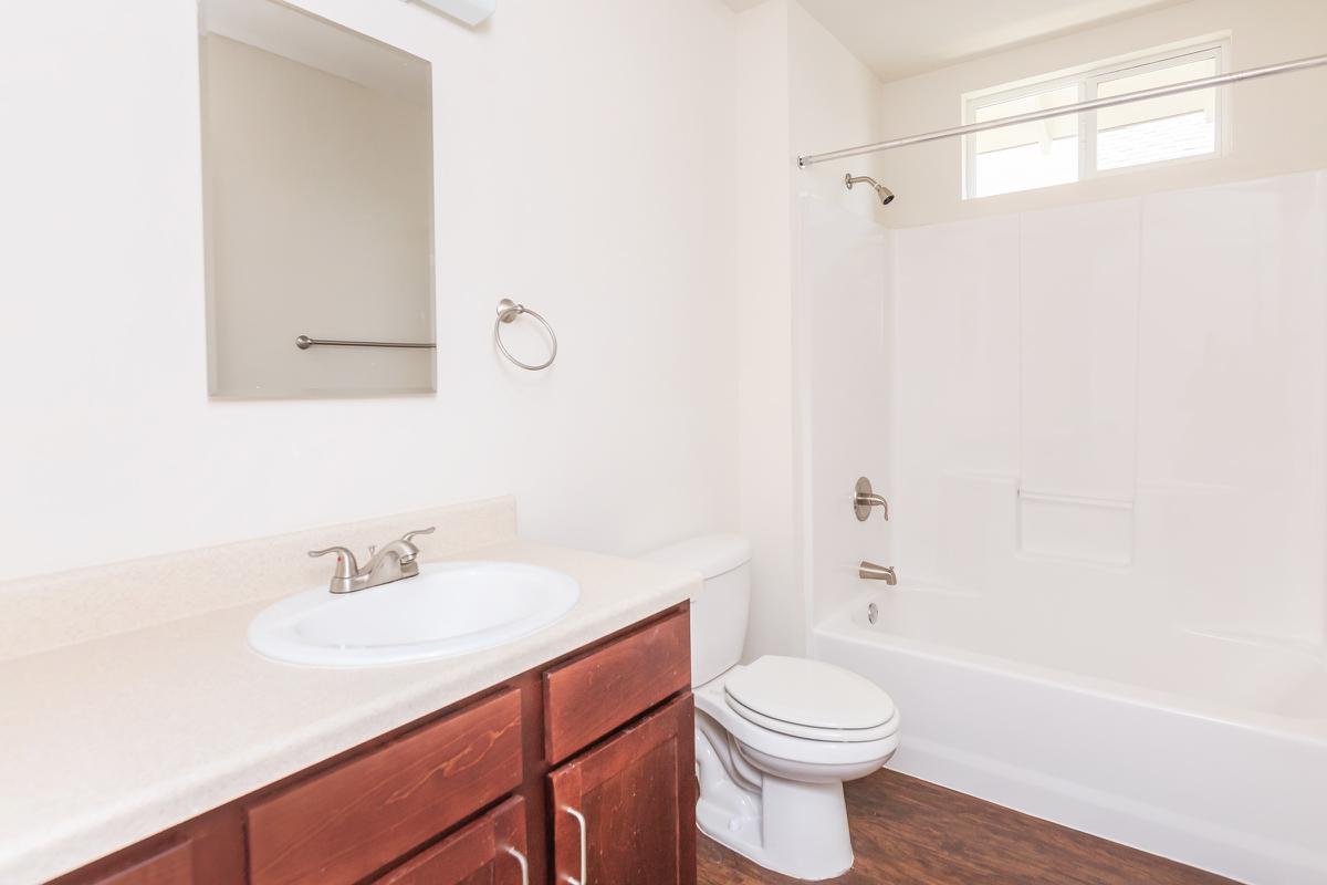 a white sink sitting next to a shower