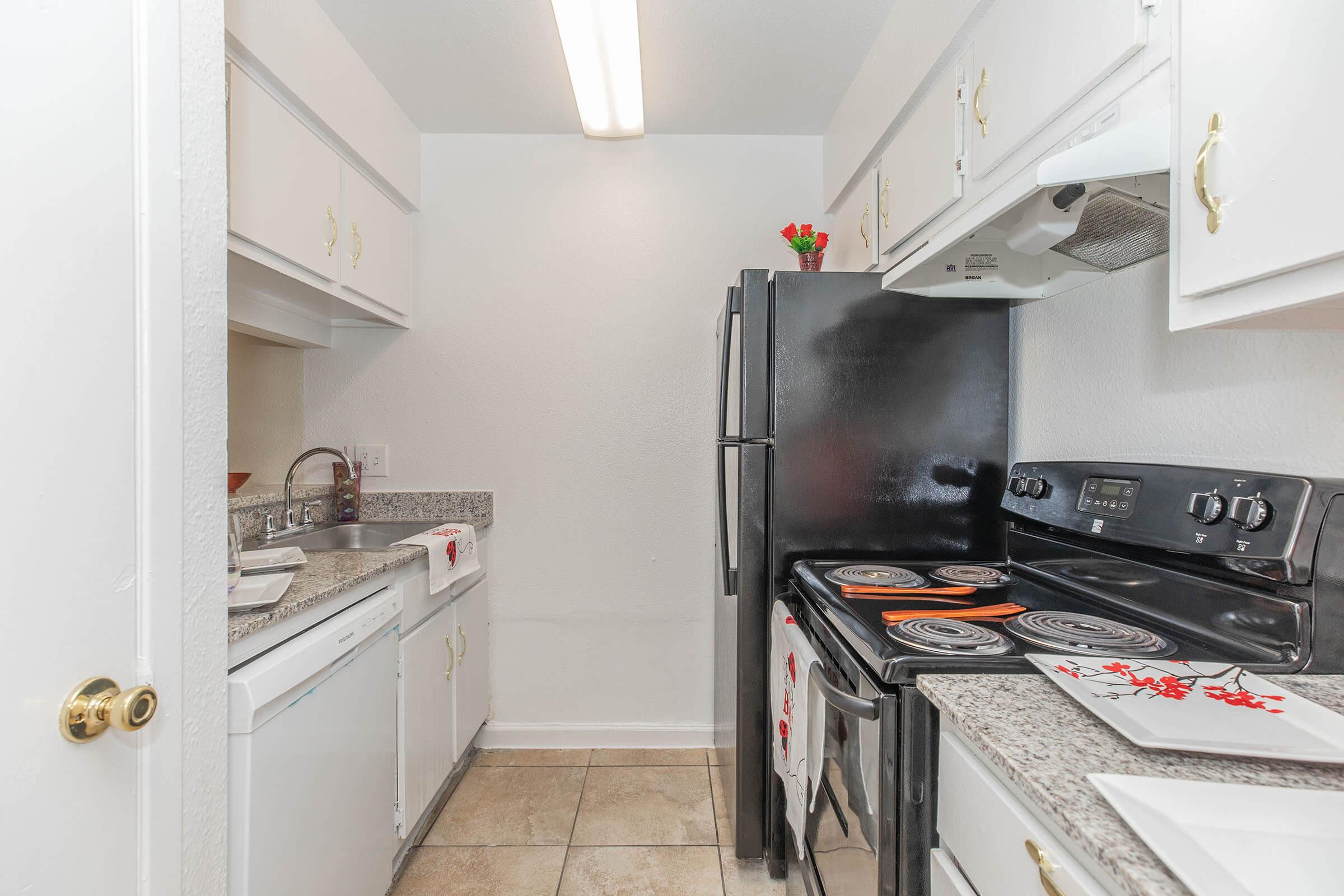 a kitchen with a stove and a refrigerator