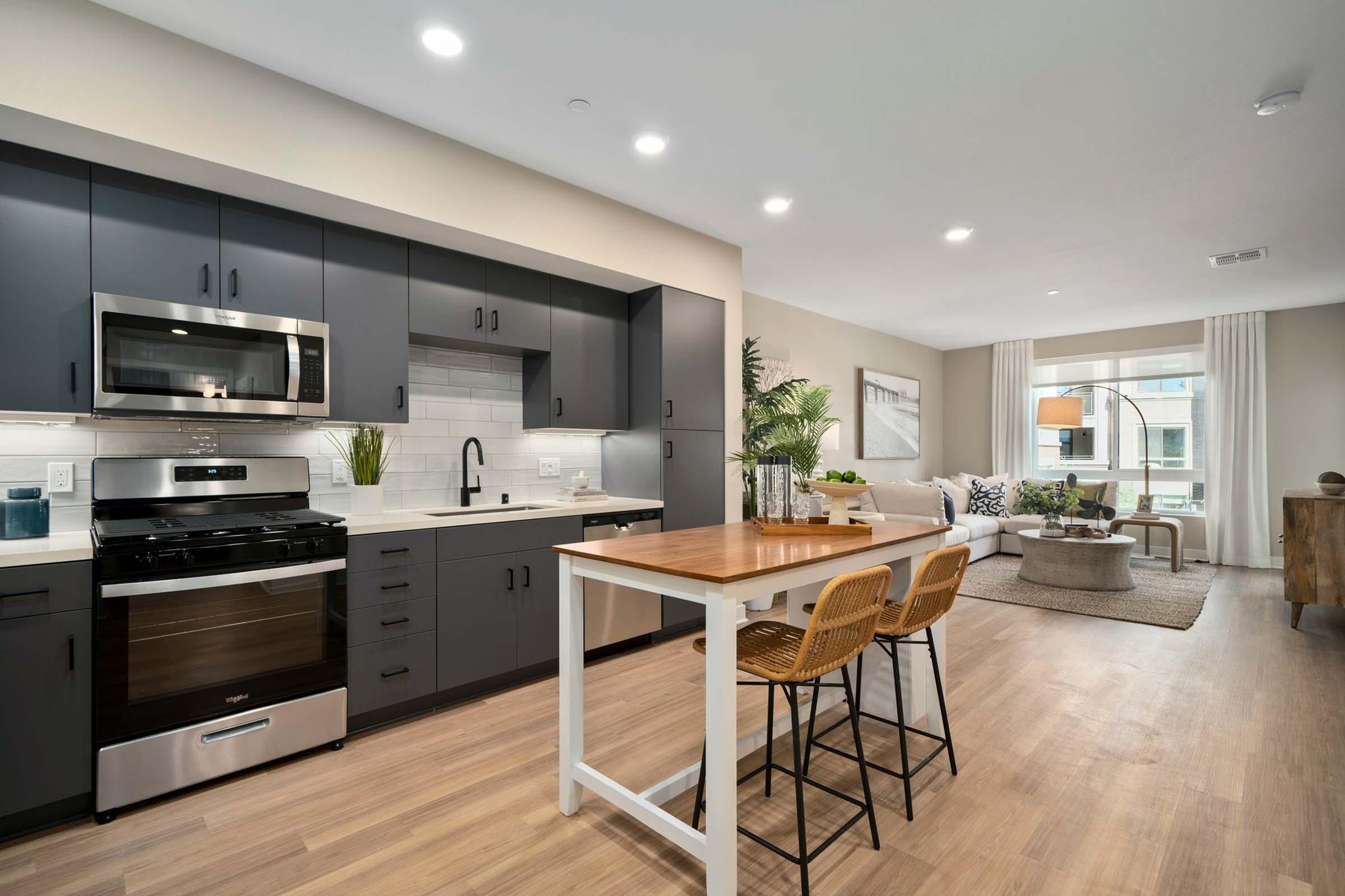 a modern kitchen with an island in the middle of a room