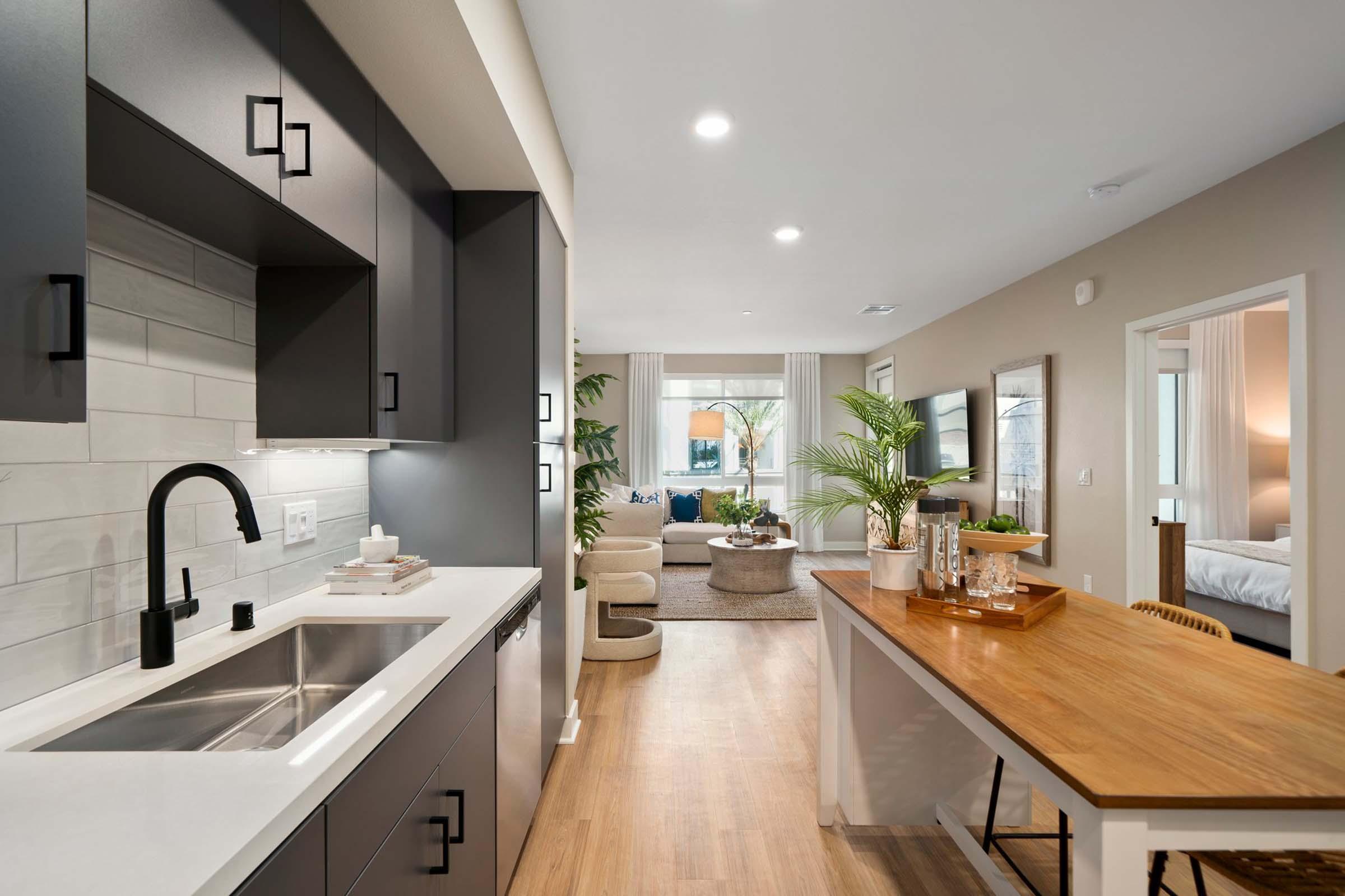 a kitchen with a sink and a mirror