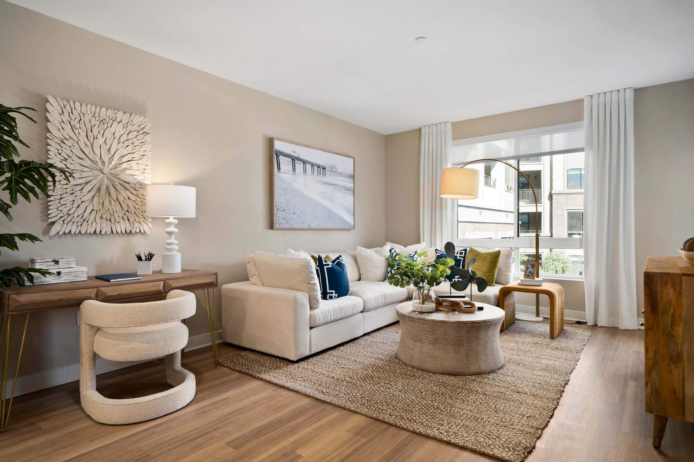 a living room filled with furniture and a large window