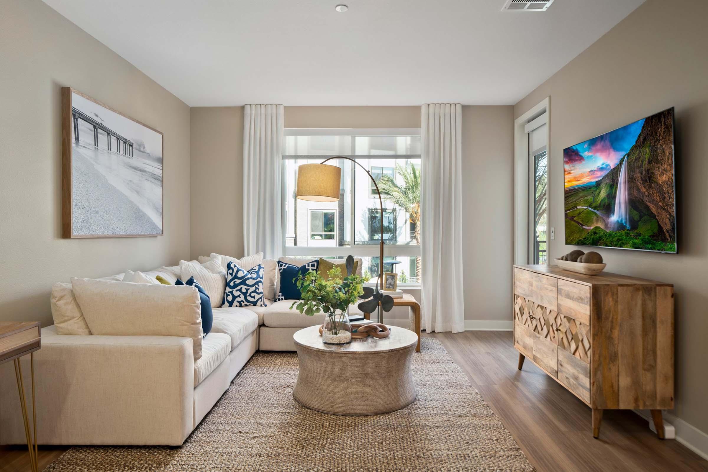 a living room filled with furniture and a large window