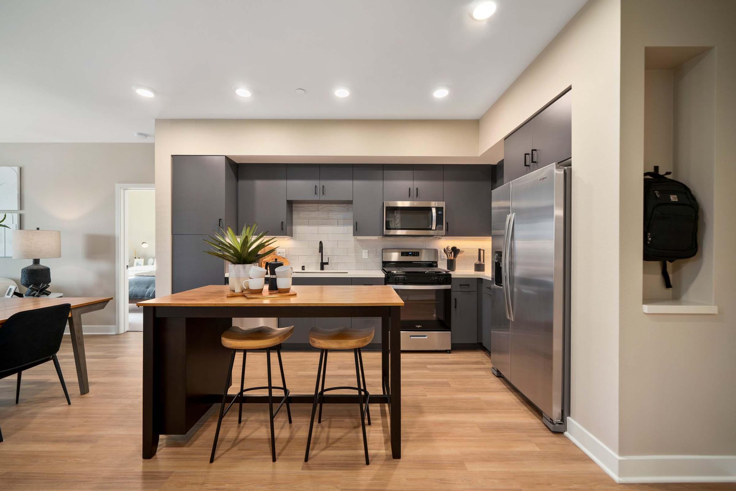 a kitchen with an island in the middle of a room