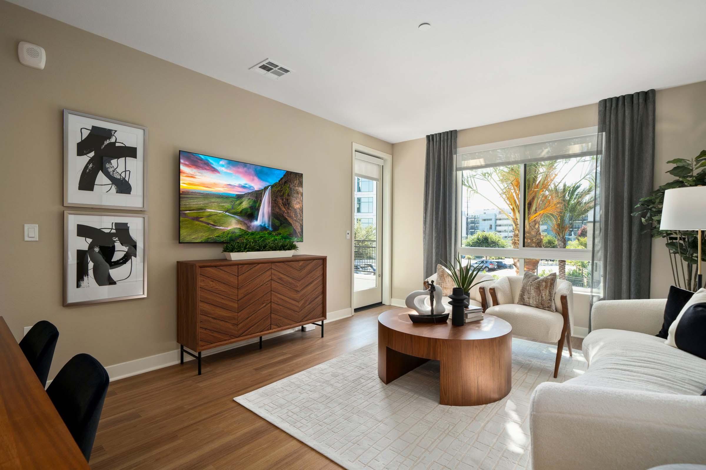 a living room filled with furniture and a large window