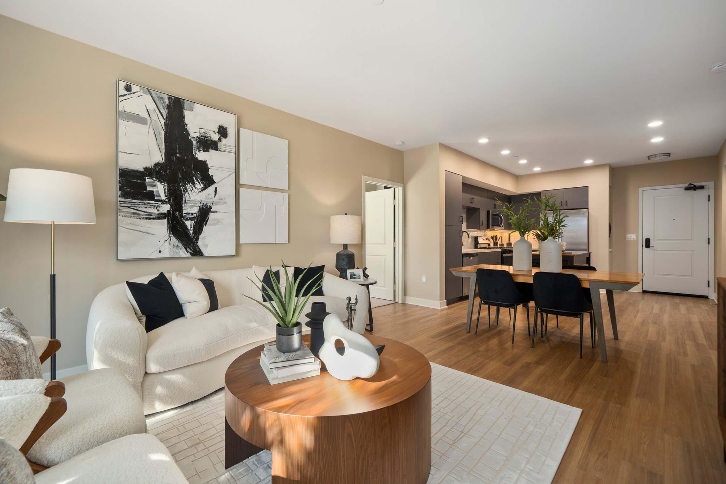 a living room filled with furniture and a wood floor