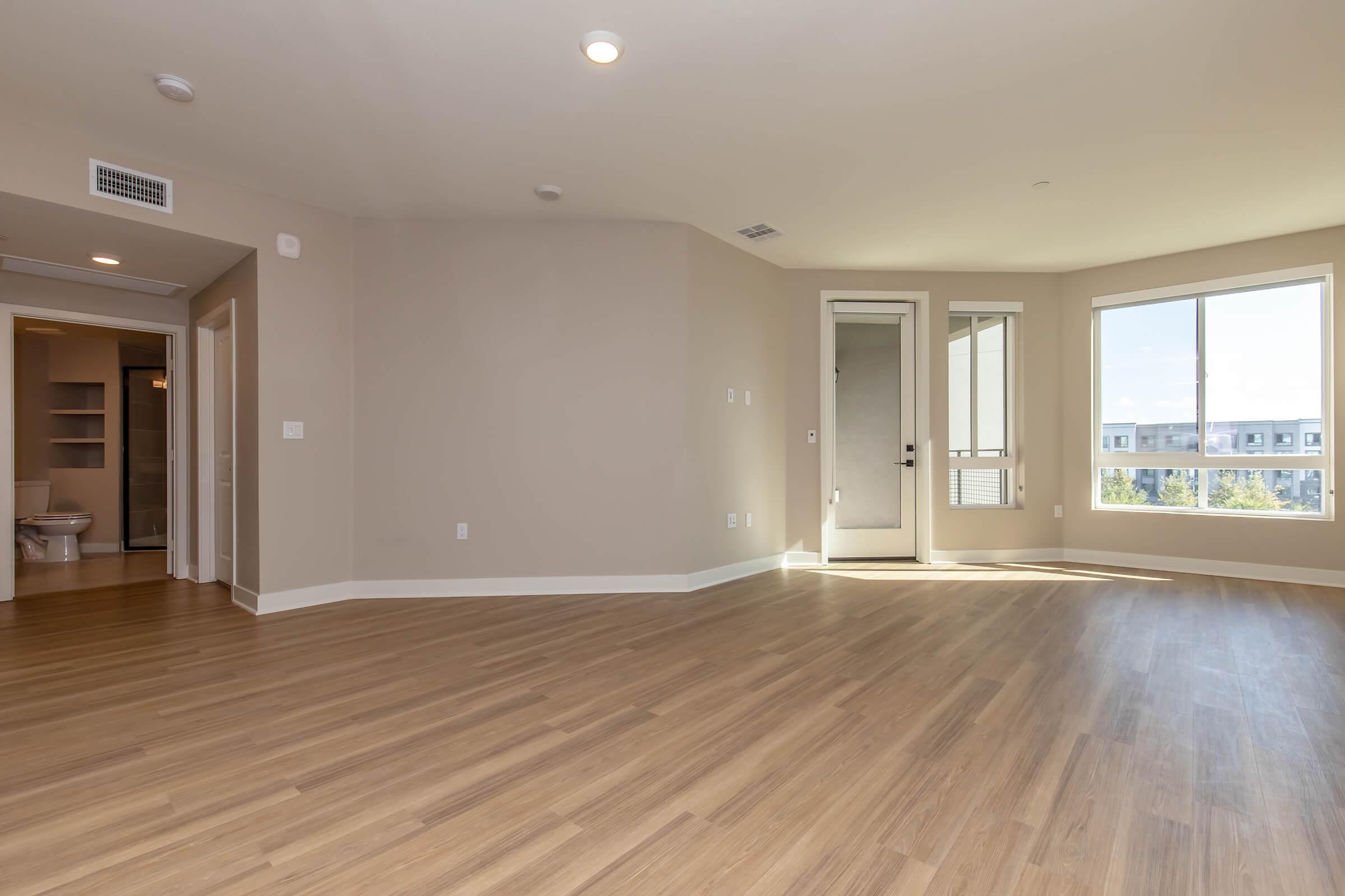 a large empty room with a wood floor