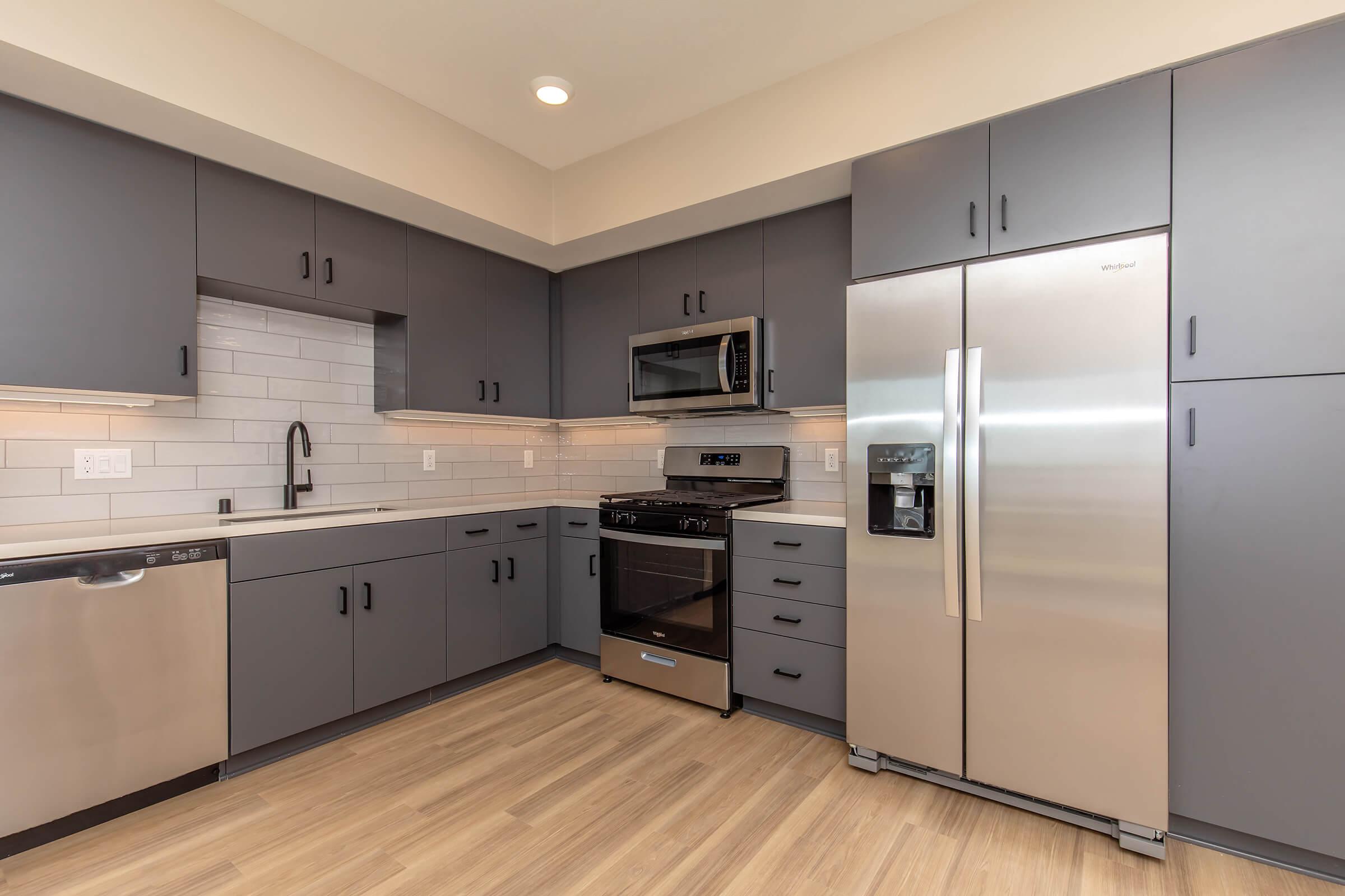 a large kitchen with stainless steel appliances