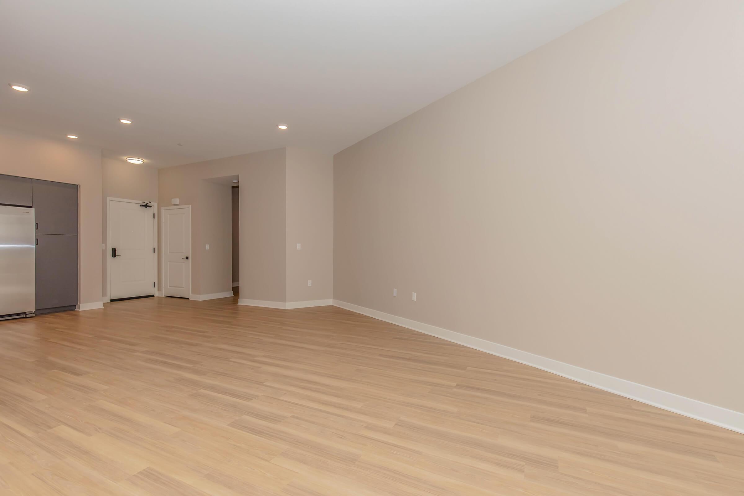 a large empty room with a wooden floor