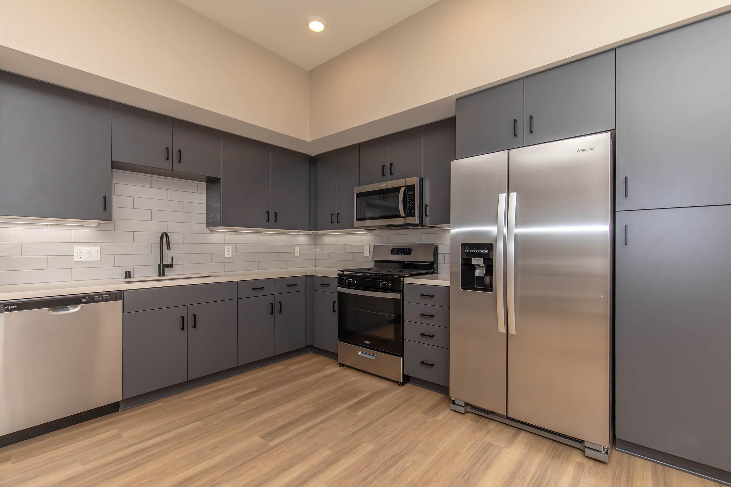 a large kitchen with stainless steel appliances