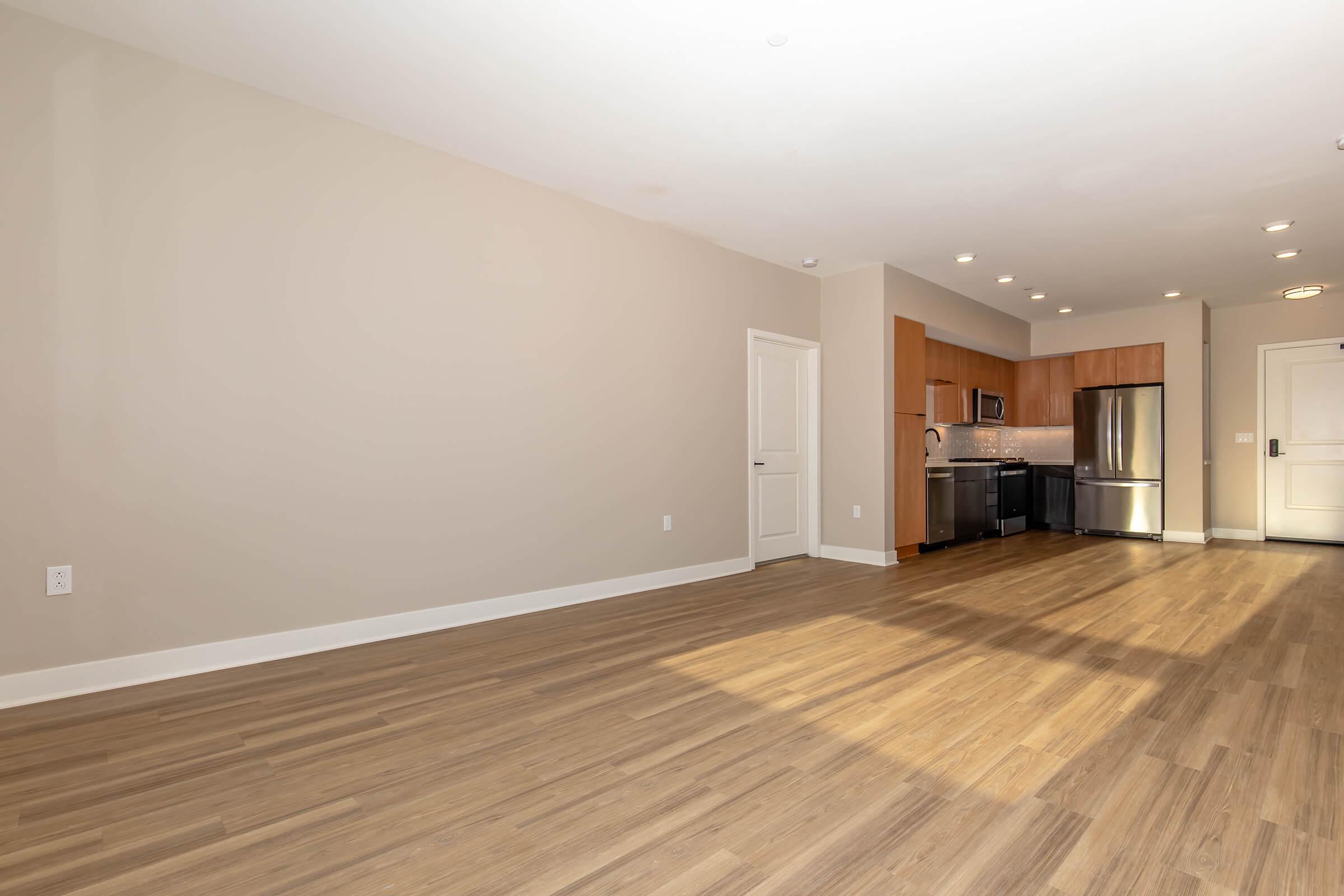 a large empty room with a wood floor