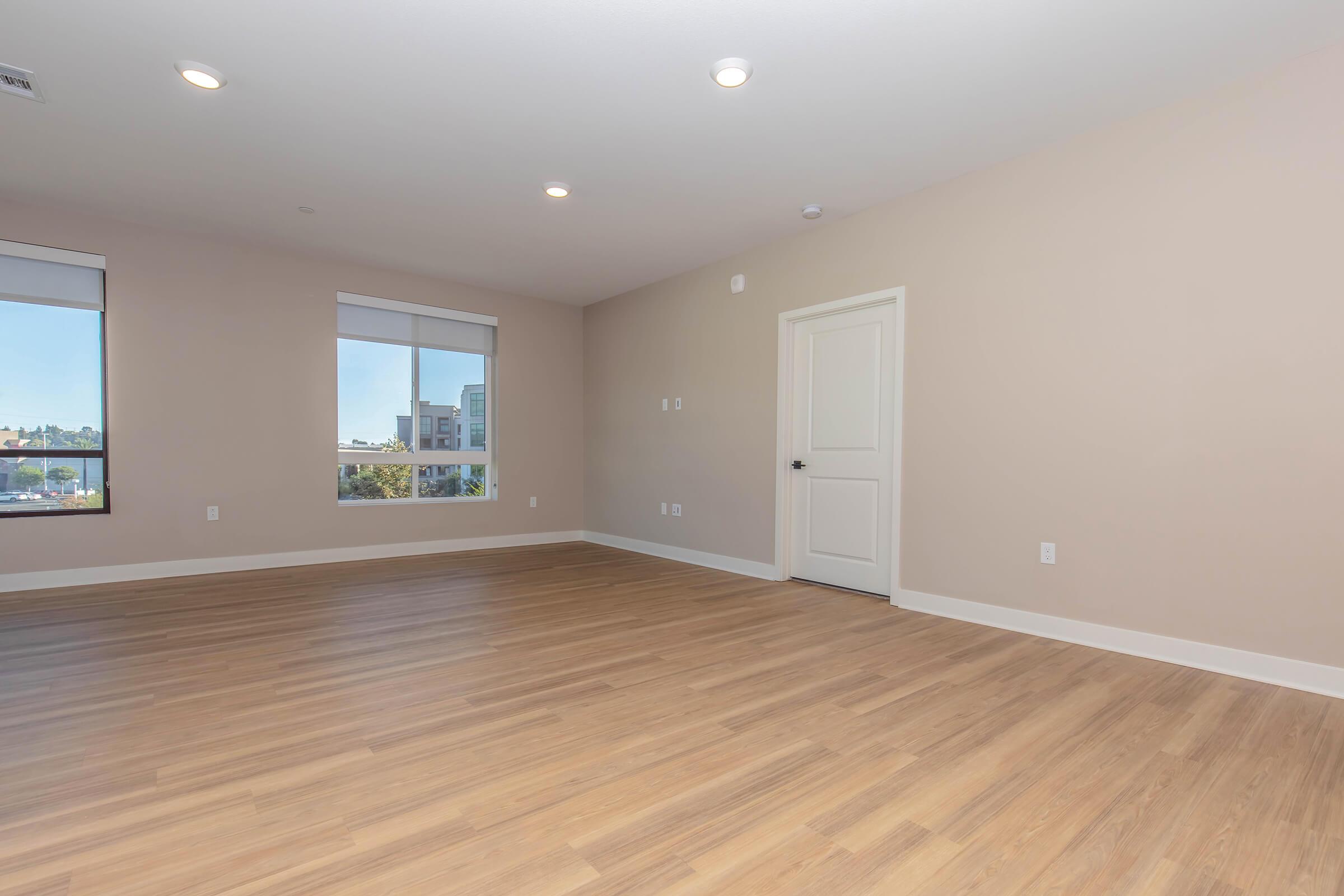 a large empty room with a wood floor