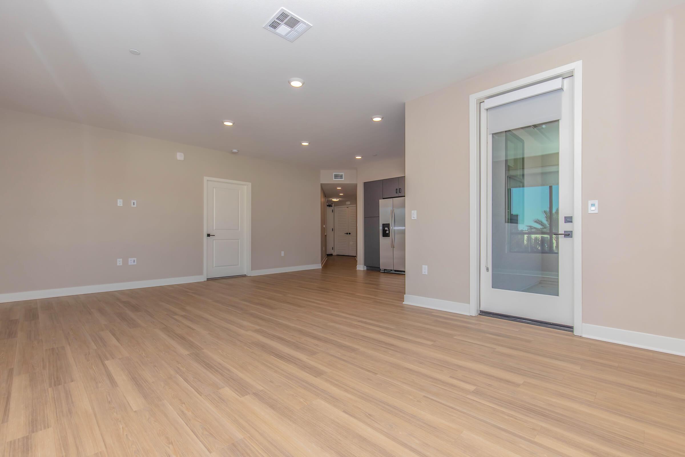 a large empty room with a wood floor