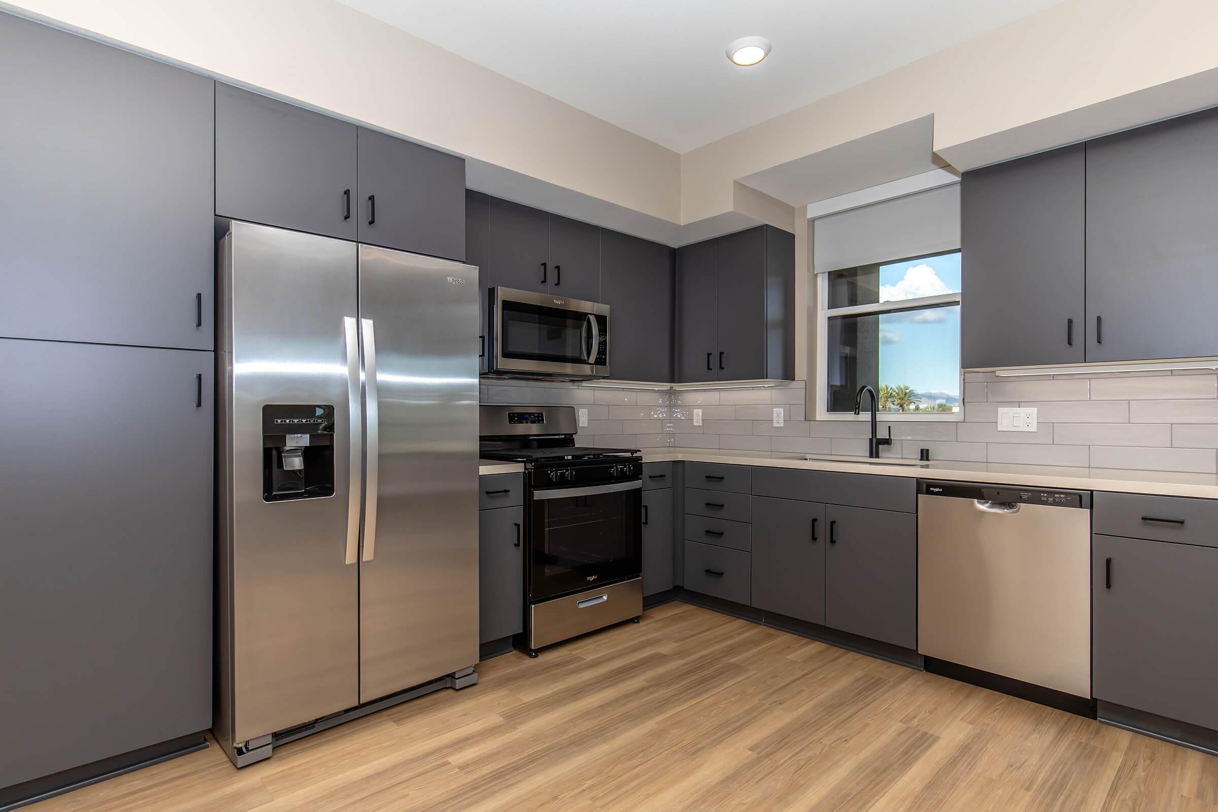 a large kitchen with stainless steel appliances