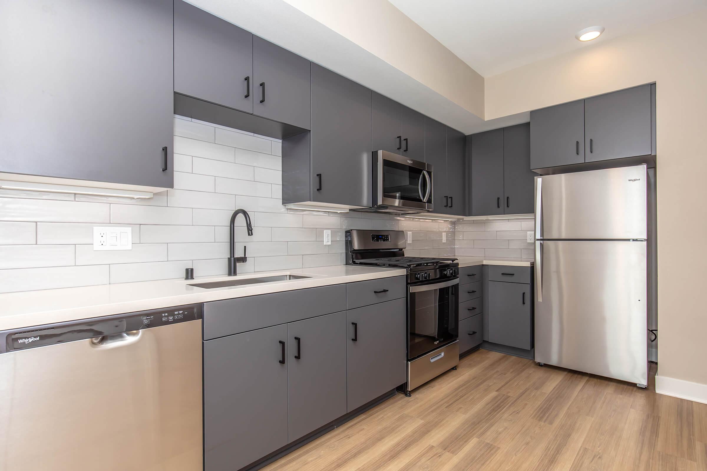 a large kitchen with stainless steel appliances