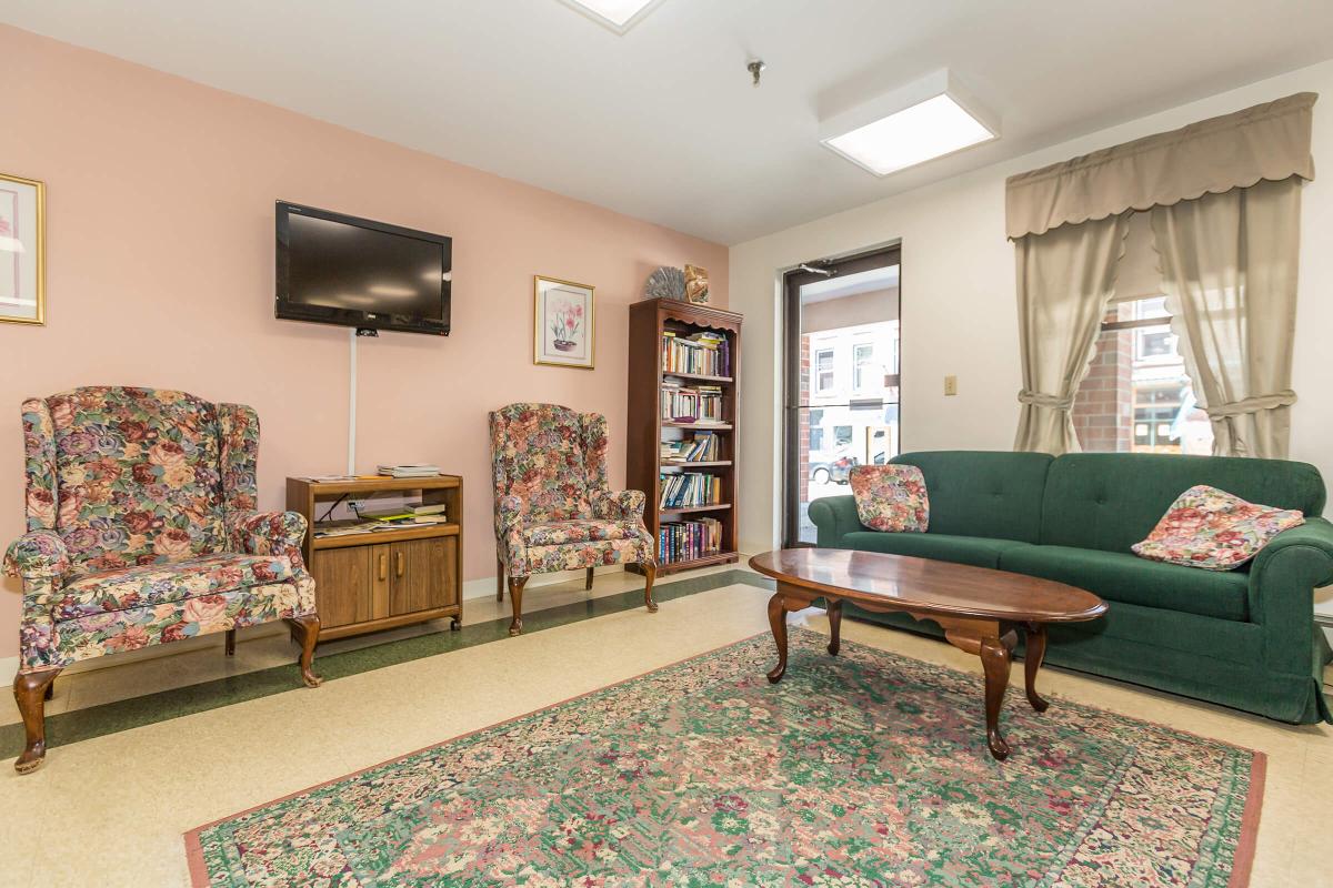 a living room filled with furniture and a rug