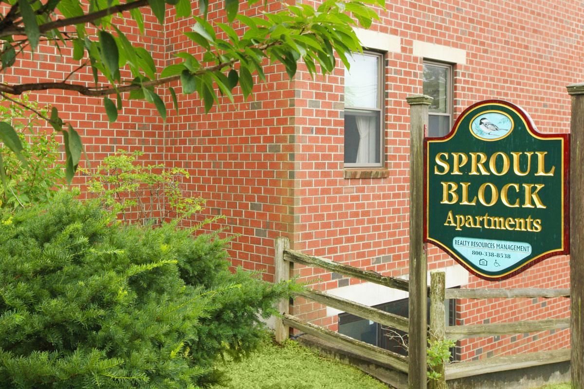 a sign in front of a brick building