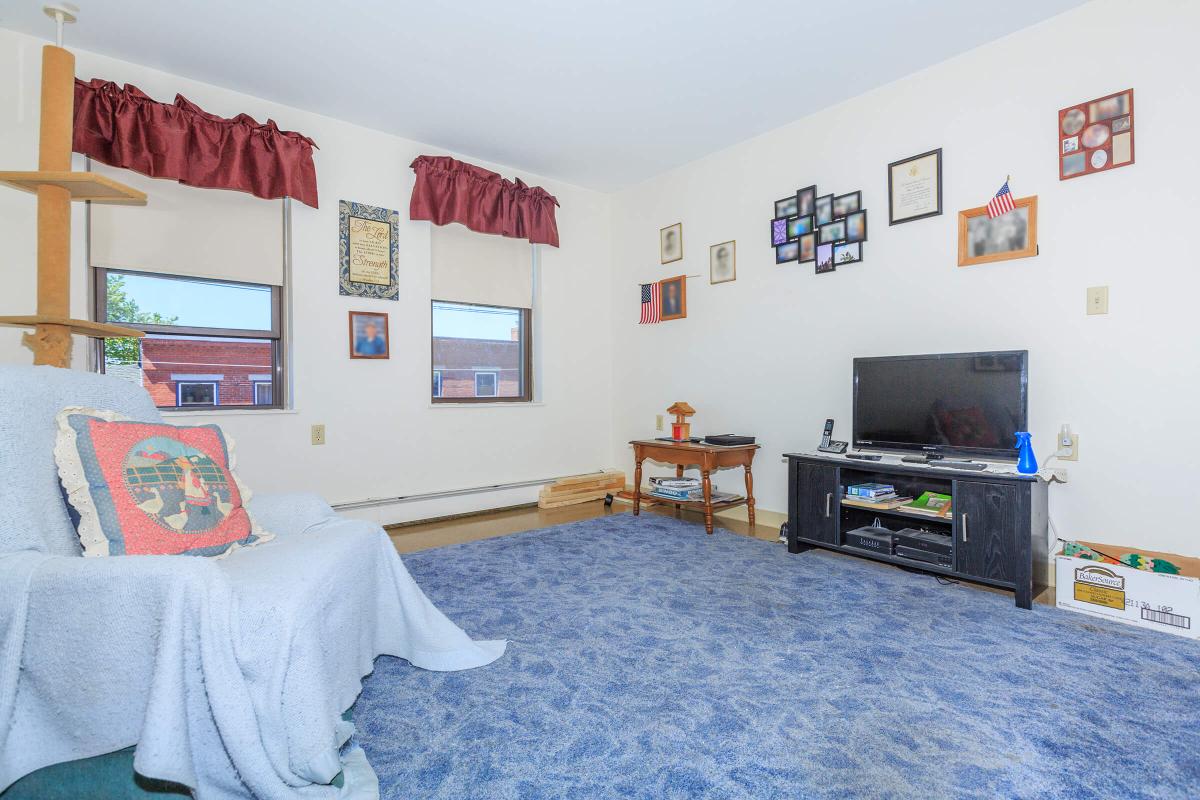 a bedroom with a bed and a couch in a living room