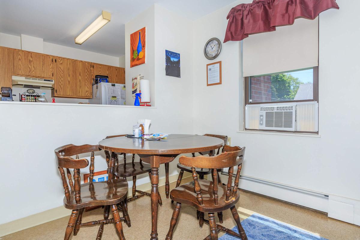 a kitchen with a table and chairs in a room