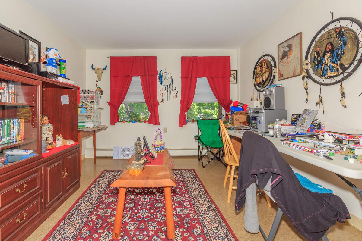 a living room filled with furniture and a flat screen tv