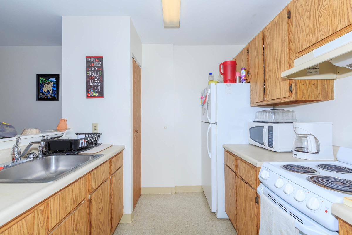 a kitchen with a stove sink and refrigerator