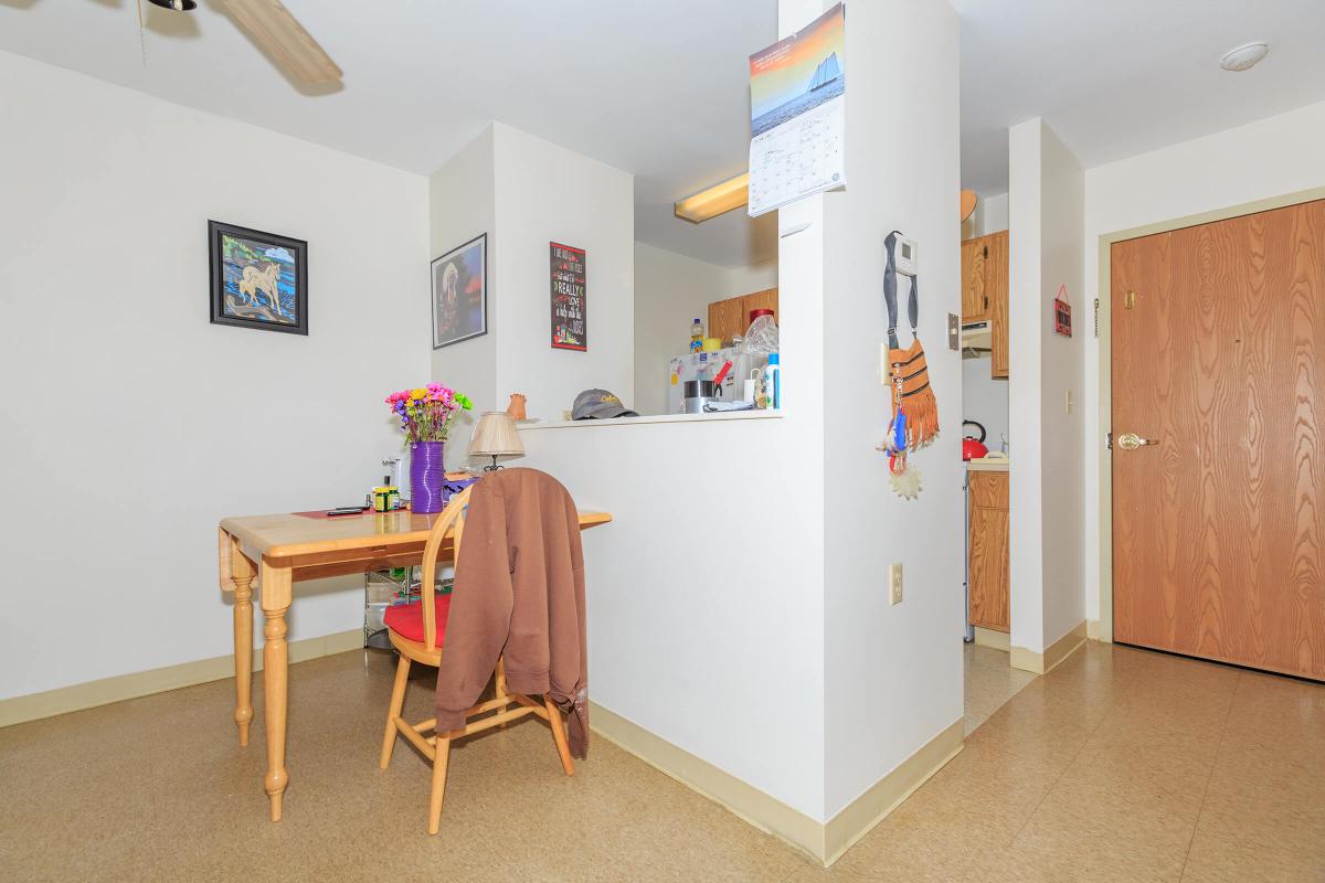 a living room filled with furniture and a refrigerator