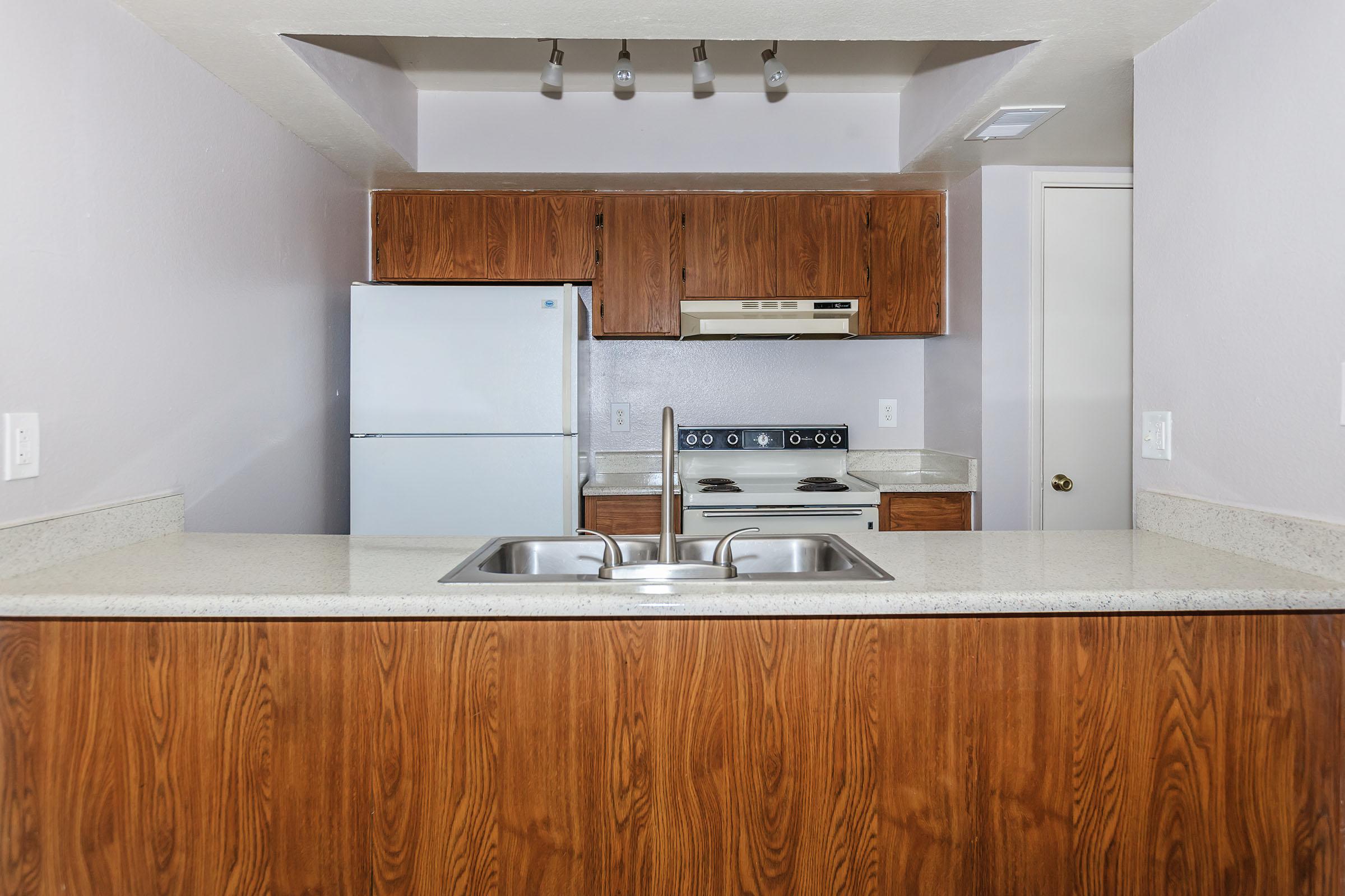 a kitchen with a sink and a refrigerator