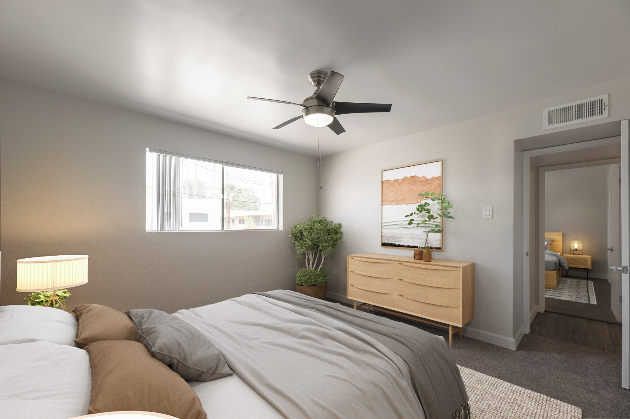 A modern bedroom featuring a gray color scheme, a large window with natural light, a cozy bed with neutral-toned bedding, a stylish dresser, a potted plant, and a ceiling fan. In the background, an open door leads to another room, adding to the spacious feel of the area.