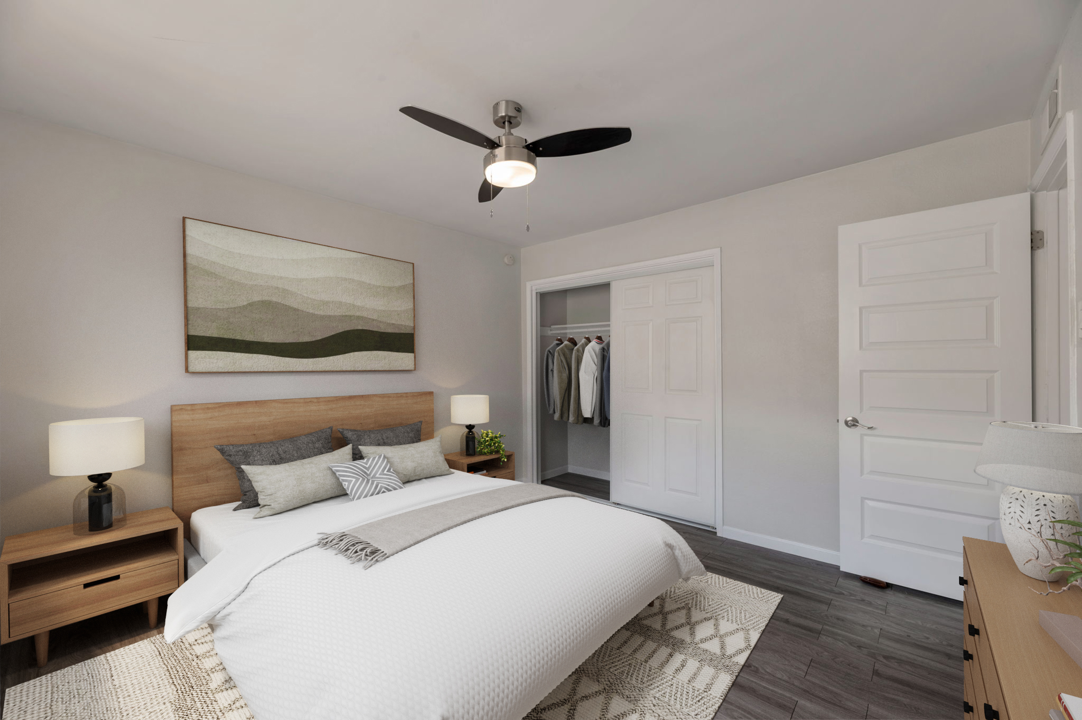A modern bedroom featuring a large bed with white bedding and decorative pillows. Two bedside lamps are on wooden nightstands. A minimalist wall art piece hangs above the bed. There's a closet with hanging clothes visible through an open door, and a neutral color palette creates a calm atmosphere.