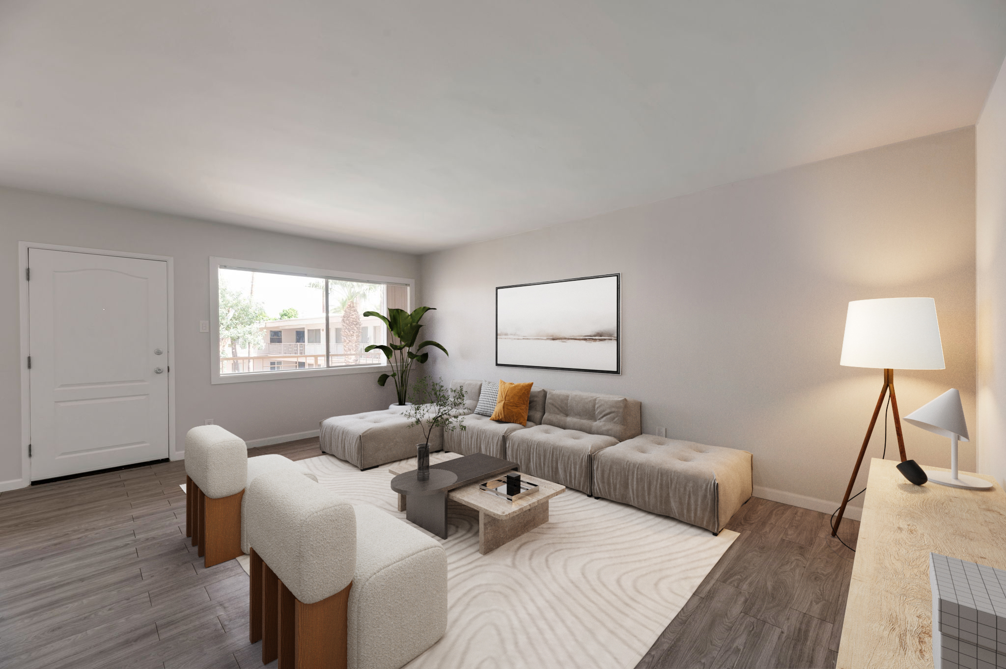 A modern living room featuring a large sectional sofa with neutral cushions, a coffee table, decorative plants, and a minimalist artwork on the wall. Natural light enters through a large window, and there is a stylish lamp and a light-colored wooden console on the side.