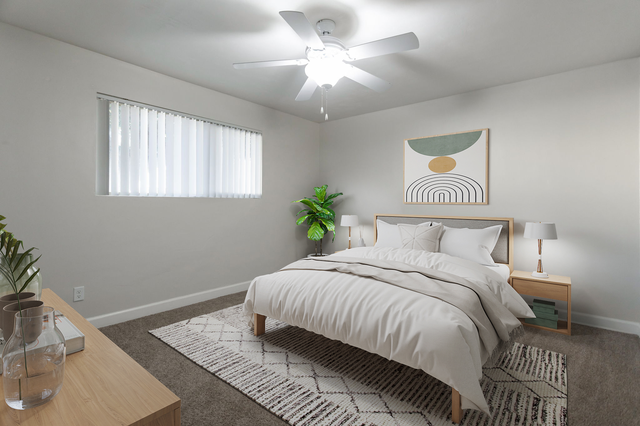 A modern bedroom featuring a cozy bed with white linens and a decorative throw, a minimalist nightstand with lamps on either side, a ceiling fan, and a large abstract wall art piece above the bed. A potted plant adds a touch of greenery, and a textured rug is placed on the carpeted floor. Natural light enters through the window with blinds.