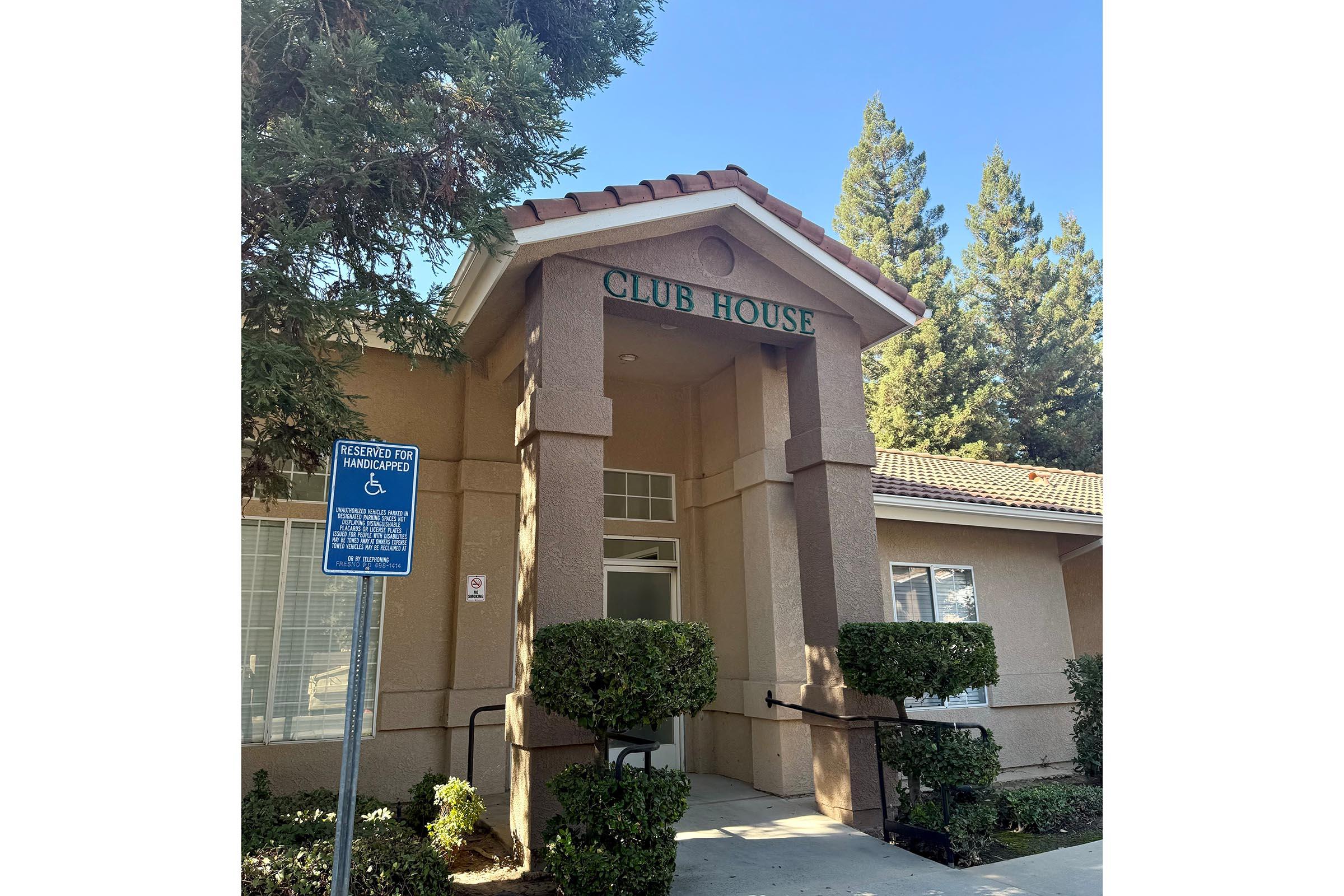 a house that has a sign on the side of a building