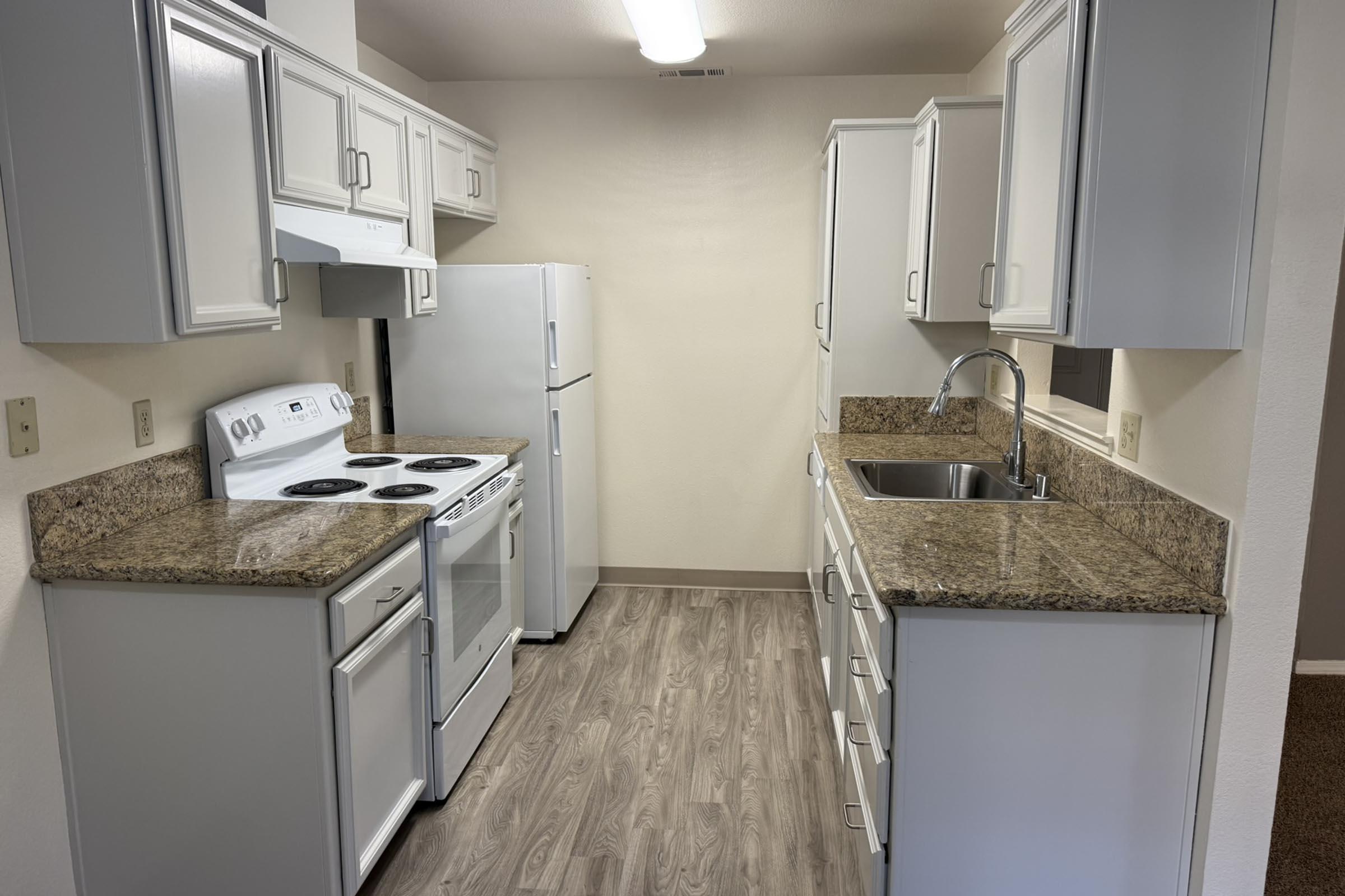 a kitchen with a sink and a mirror