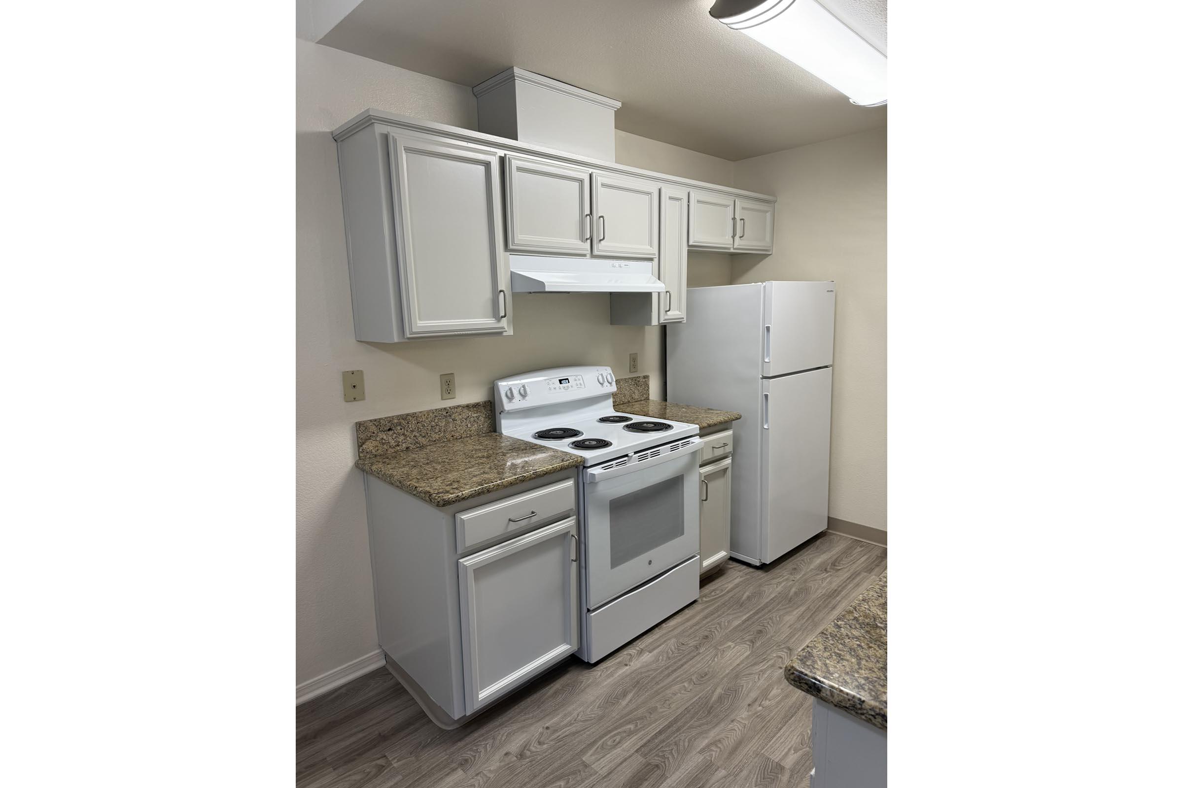 a kitchen with a sink and a mirror